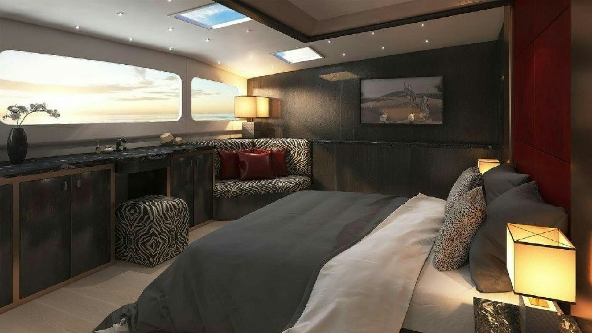 a bedroom with a bed and a desk aboard SKYE Yacht for Sale