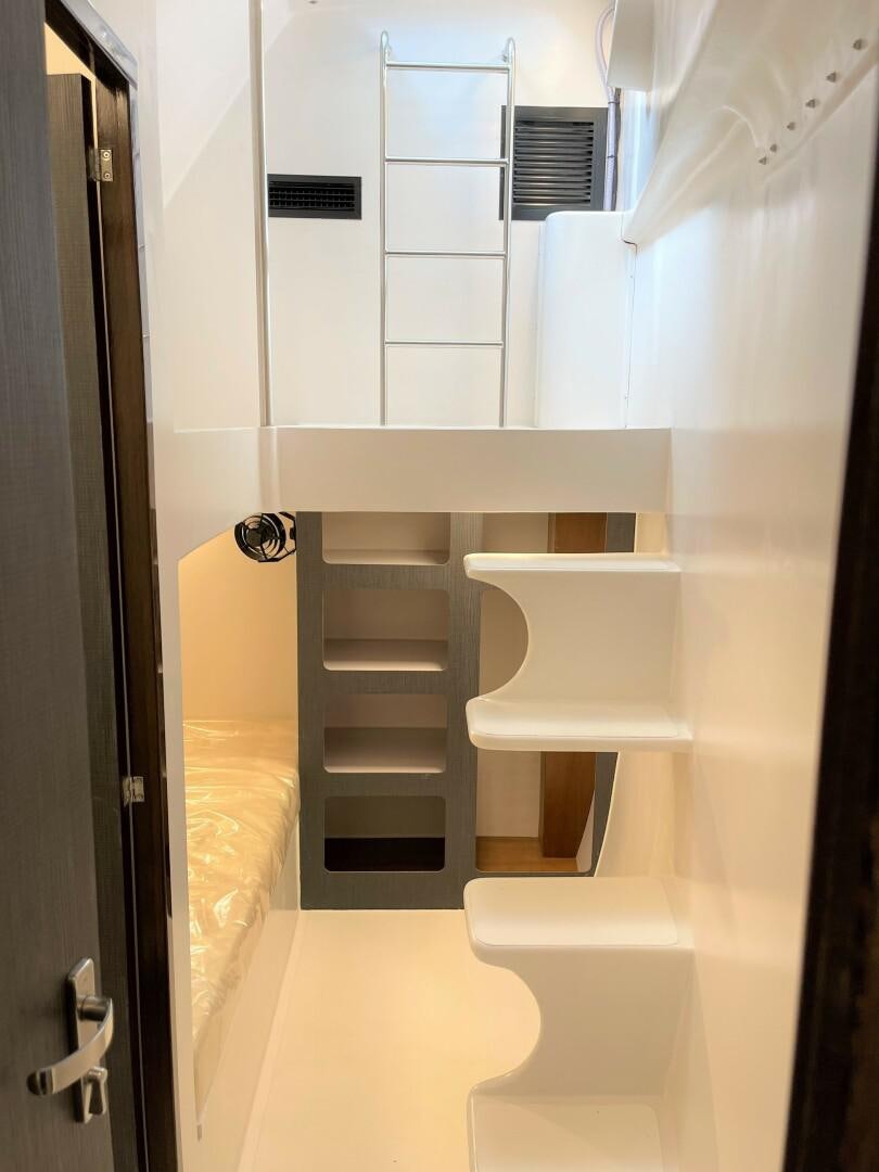 a white and black bunk bed aboard SKYE Yacht for Sale