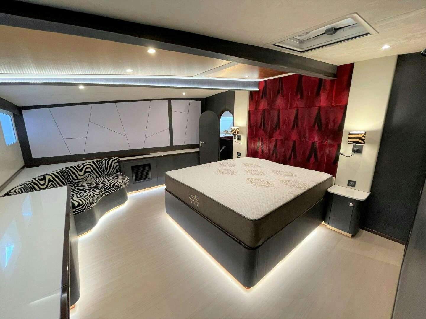 a room with a bed and a red curtain aboard SKYE Yacht for Sale