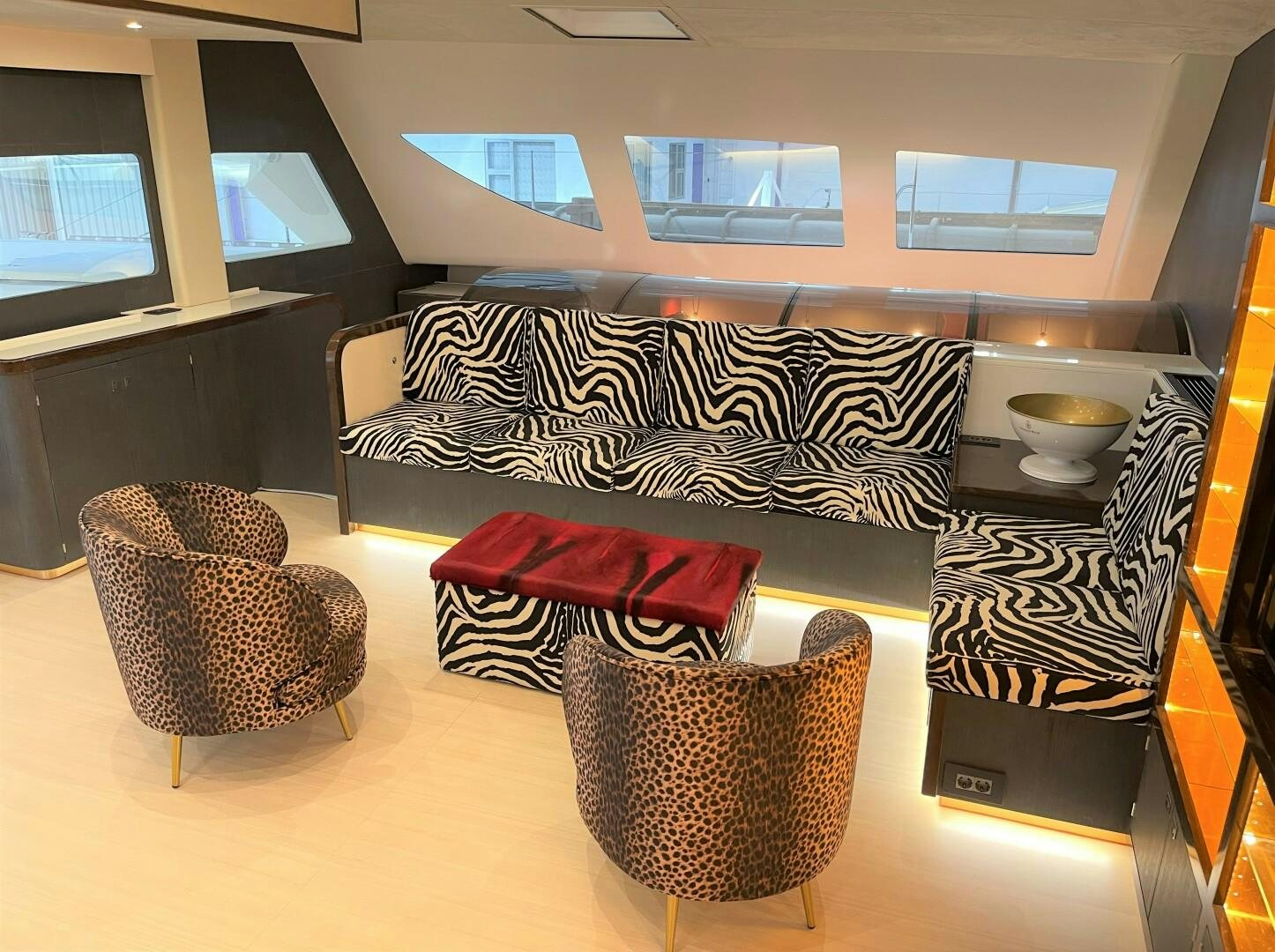 a room with a couch and a table with chairs aboard SKYE Yacht for Sale