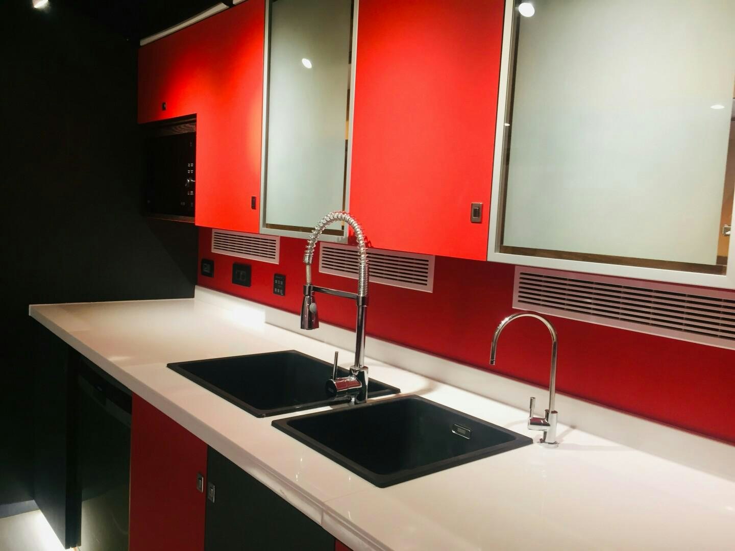 a kitchen with red cabinets aboard SKYE Yacht for Sale