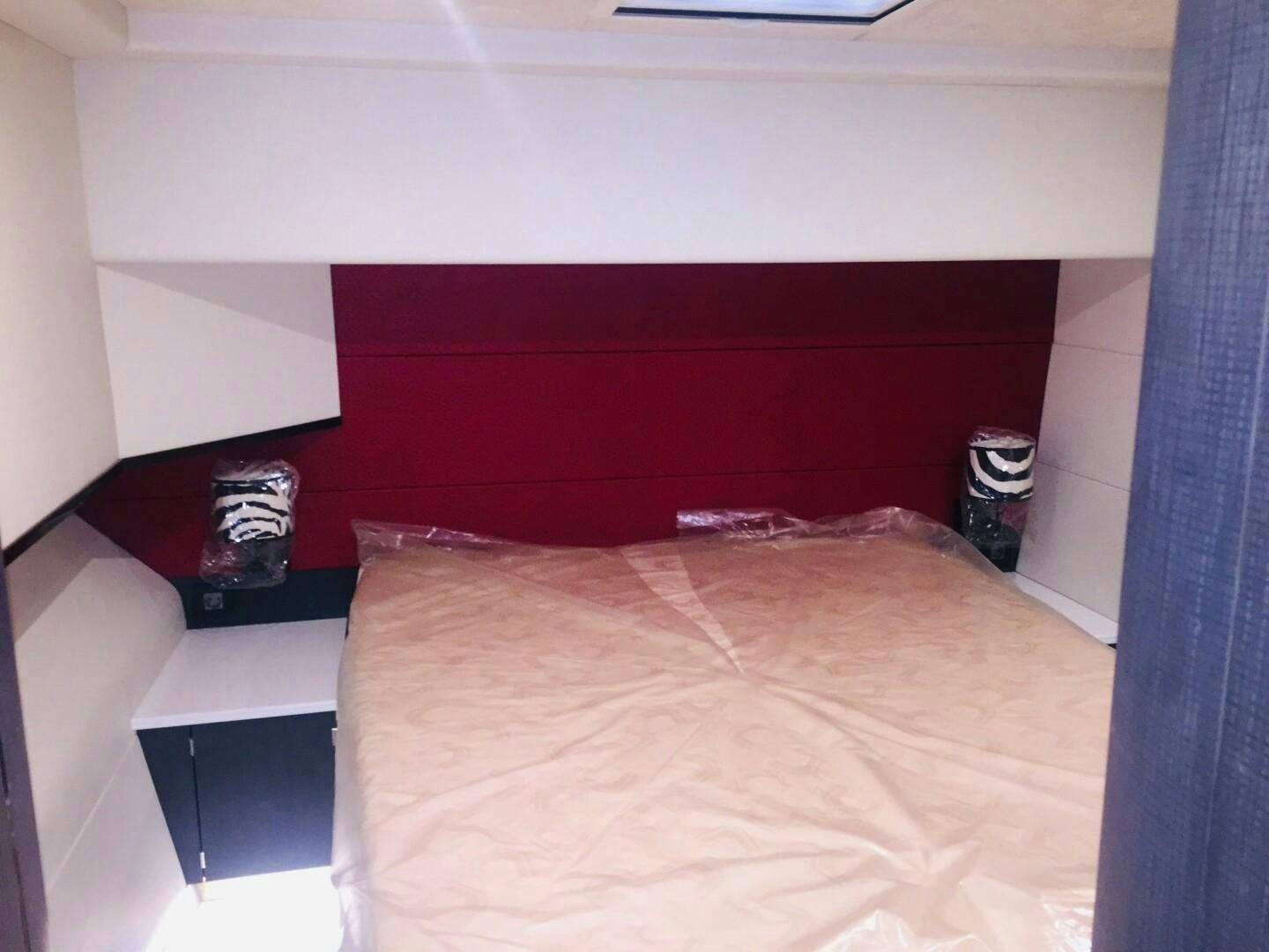 a bed with a red blanket aboard SKYE Yacht for Sale