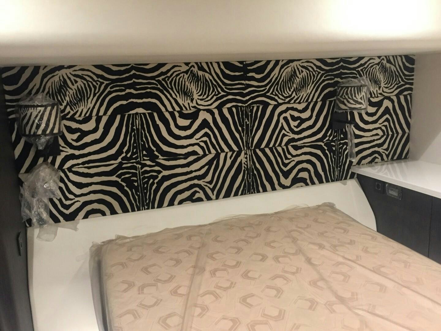 a bed with a white sheet aboard SKYE Yacht for Sale