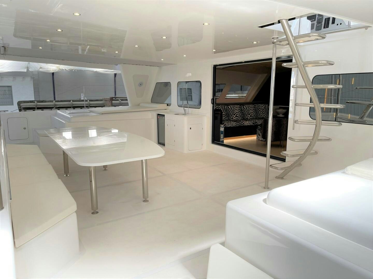 a room with a table and chairs aboard SKYE Yacht for Sale
