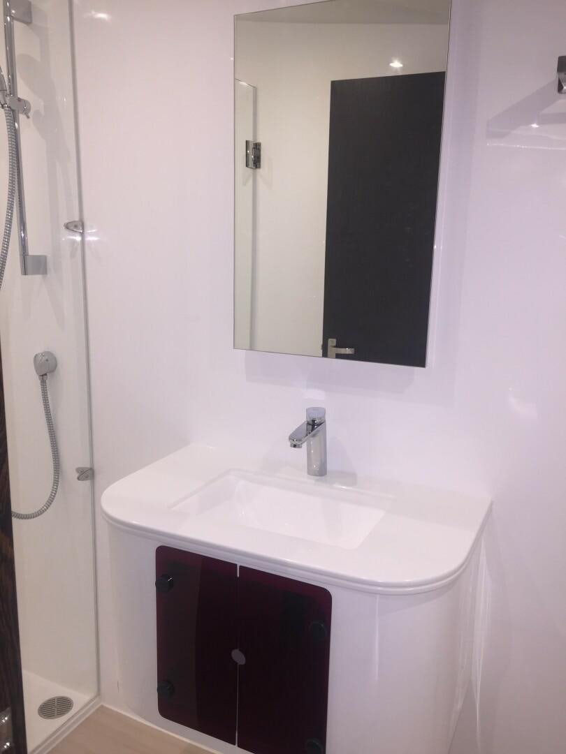 a bathroom with a mirror and a sink aboard SKYE Yacht for Sale