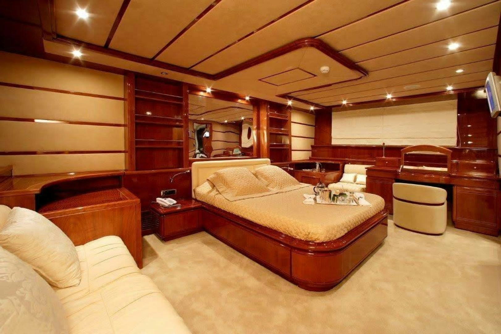 a room with a bed and a couch aboard CORVUS Yacht for Sale