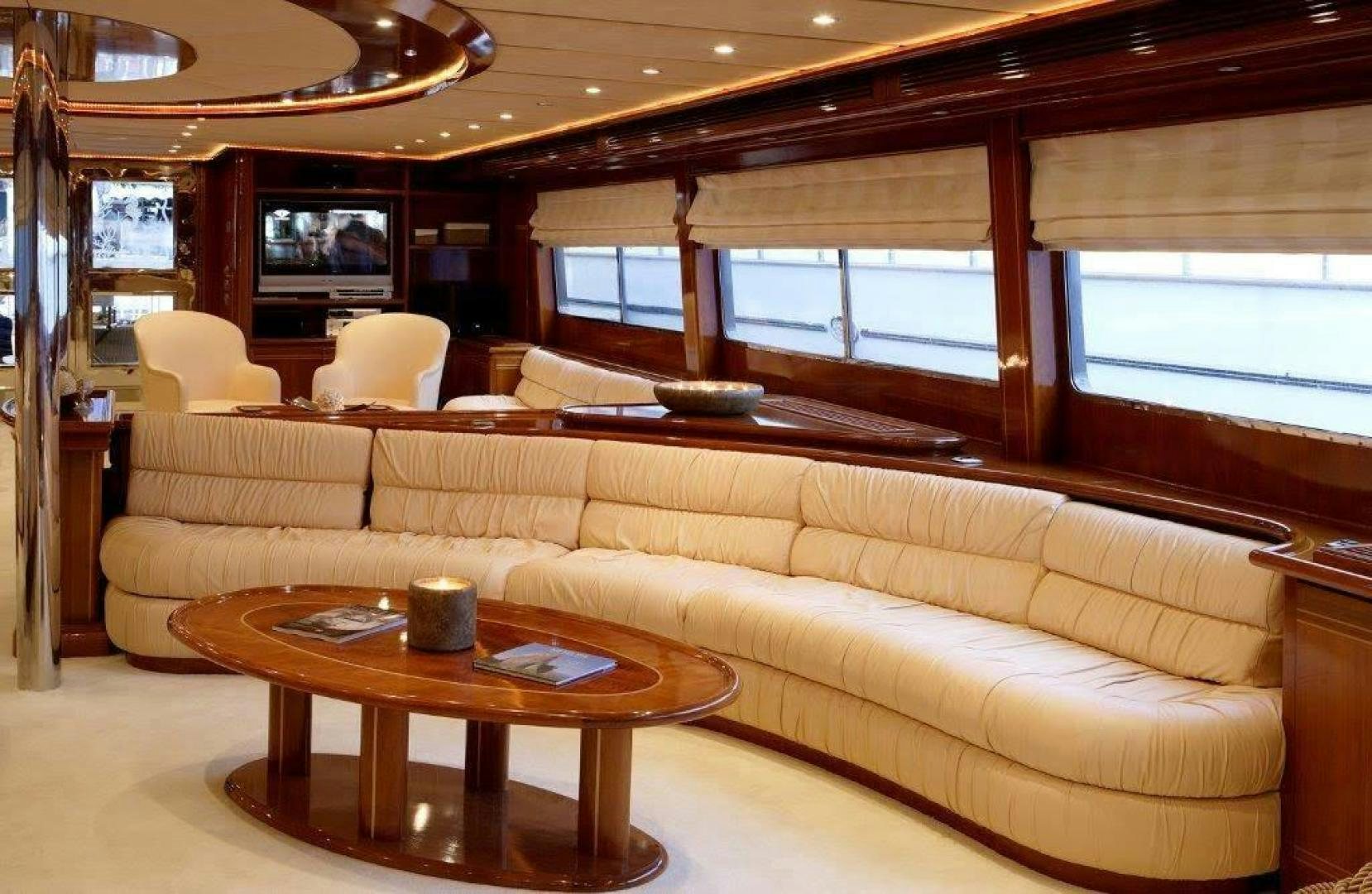 a living room with a couch and a coffee table aboard CORVUS Yacht for Sale