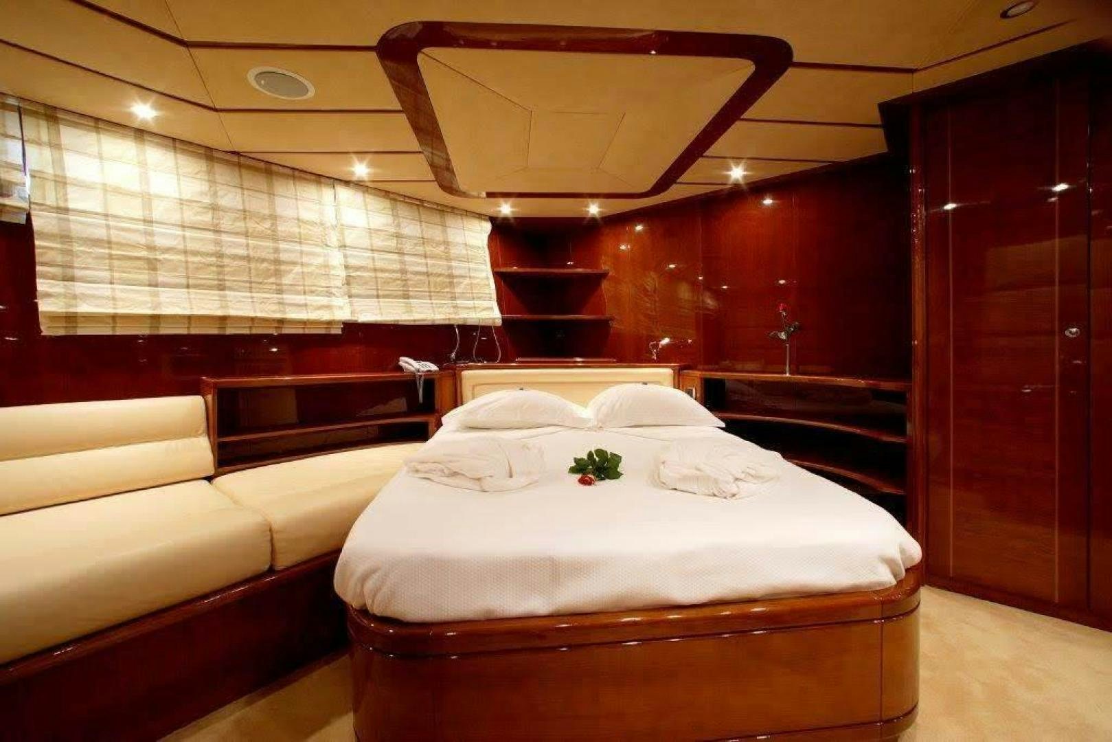 a room with a bed and a mirror aboard CORVUS Yacht for Sale