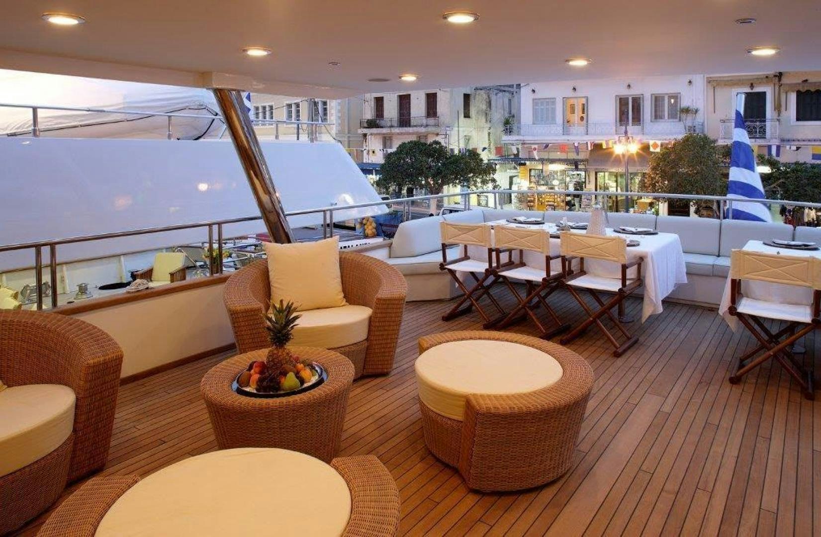 a room with a table chairs and a large window aboard CORVUS Yacht for Sale