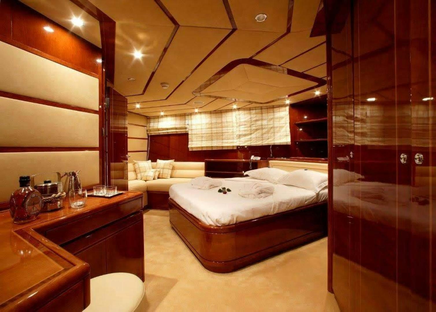 a room with a bed and a glass wall aboard CORVUS Yacht for Sale