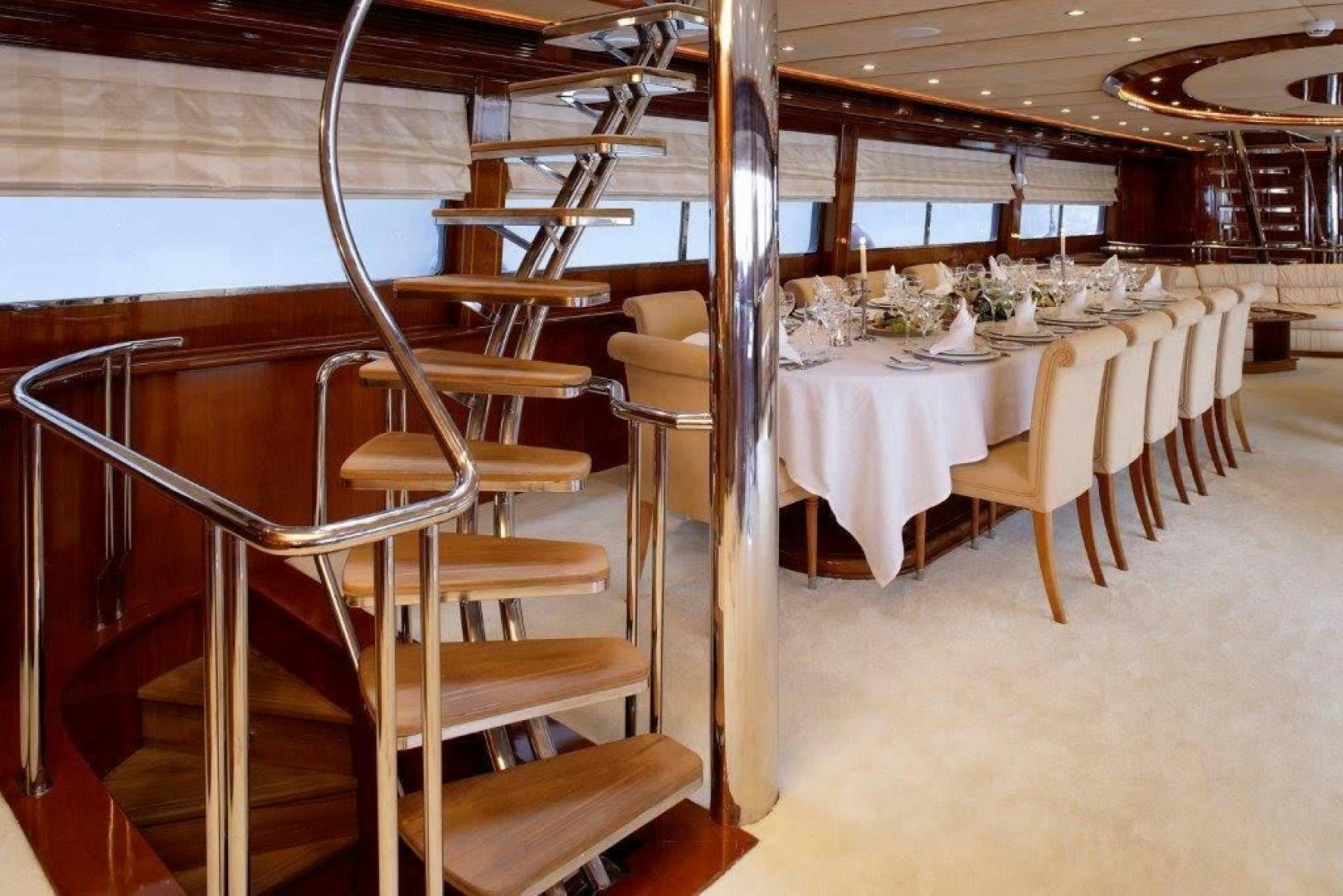 a dining room with tables and chairs aboard CORVUS Yacht for Sale