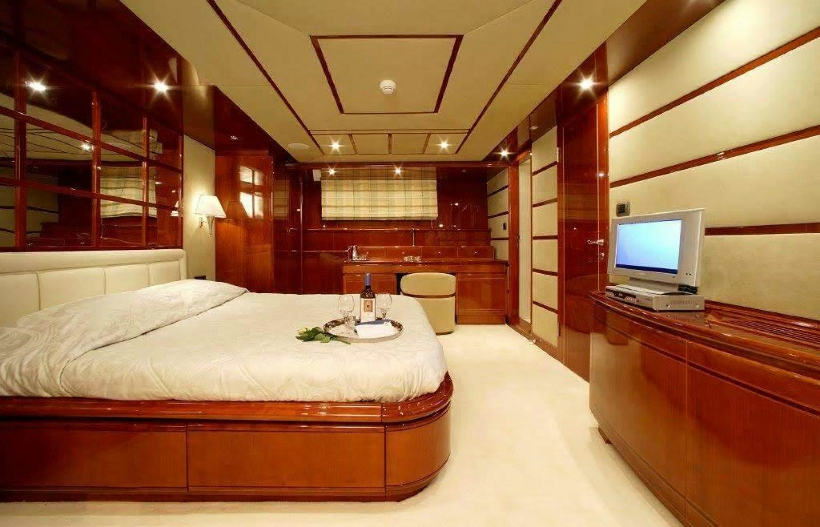 a room with a bed and a television aboard CORVUS Yacht for Sale