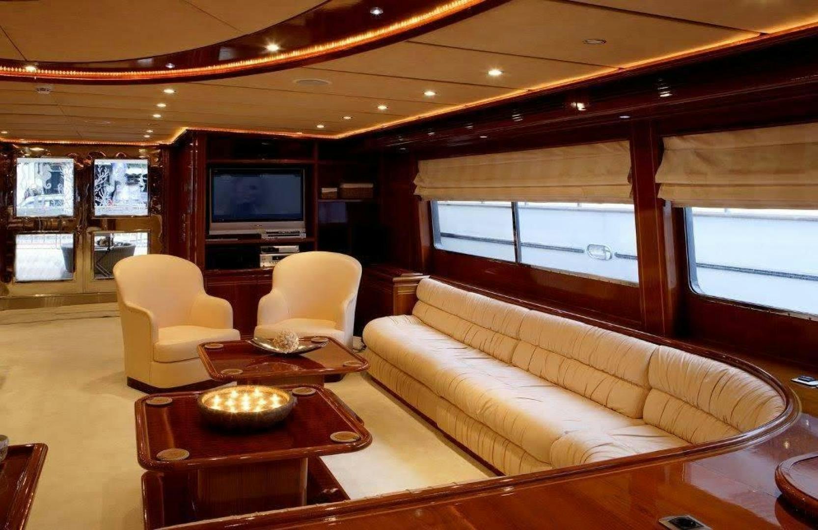a living room with a couch and a television aboard CORVUS Yacht for Sale