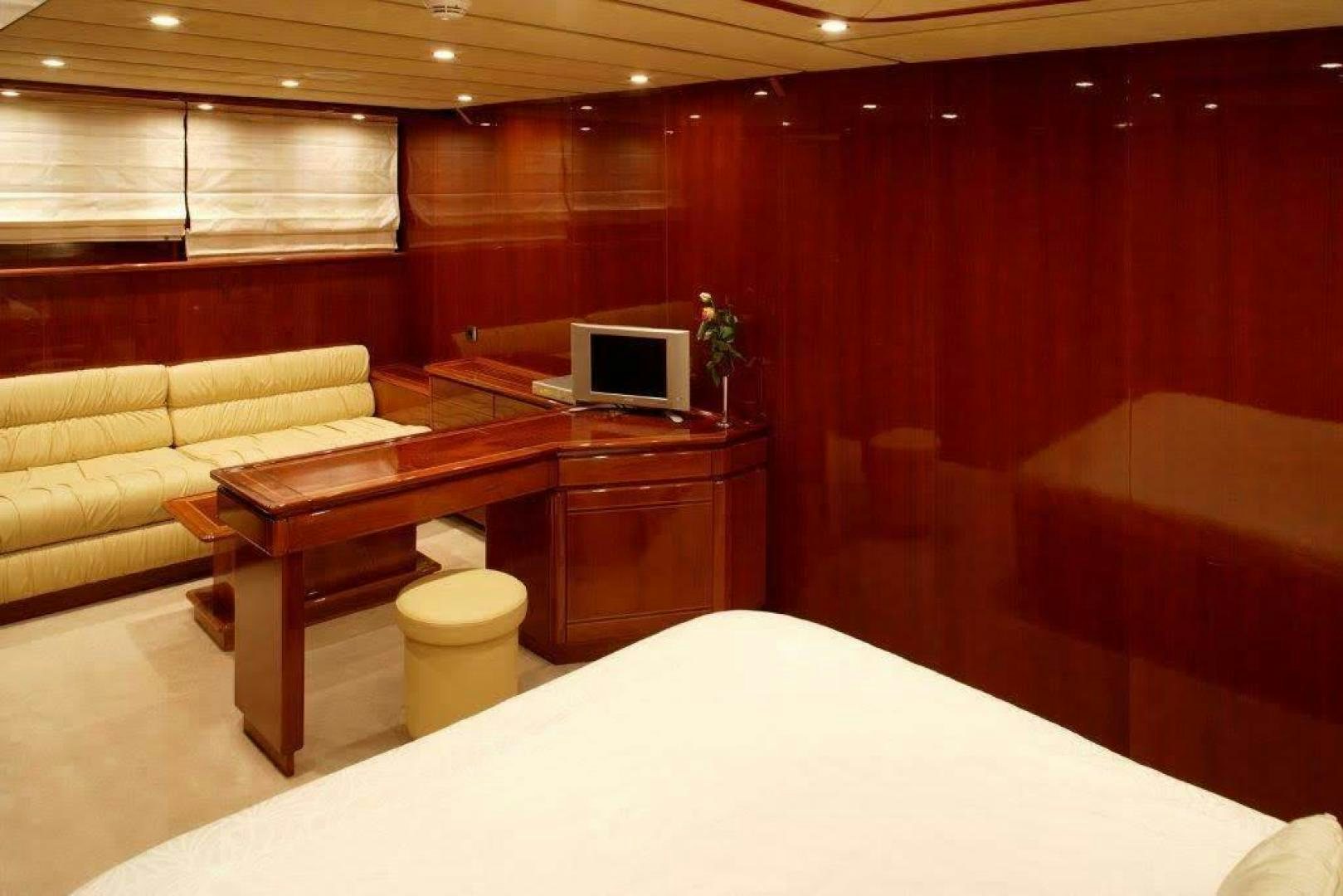 a room with a couch and a desk aboard CORVUS Yacht for Sale