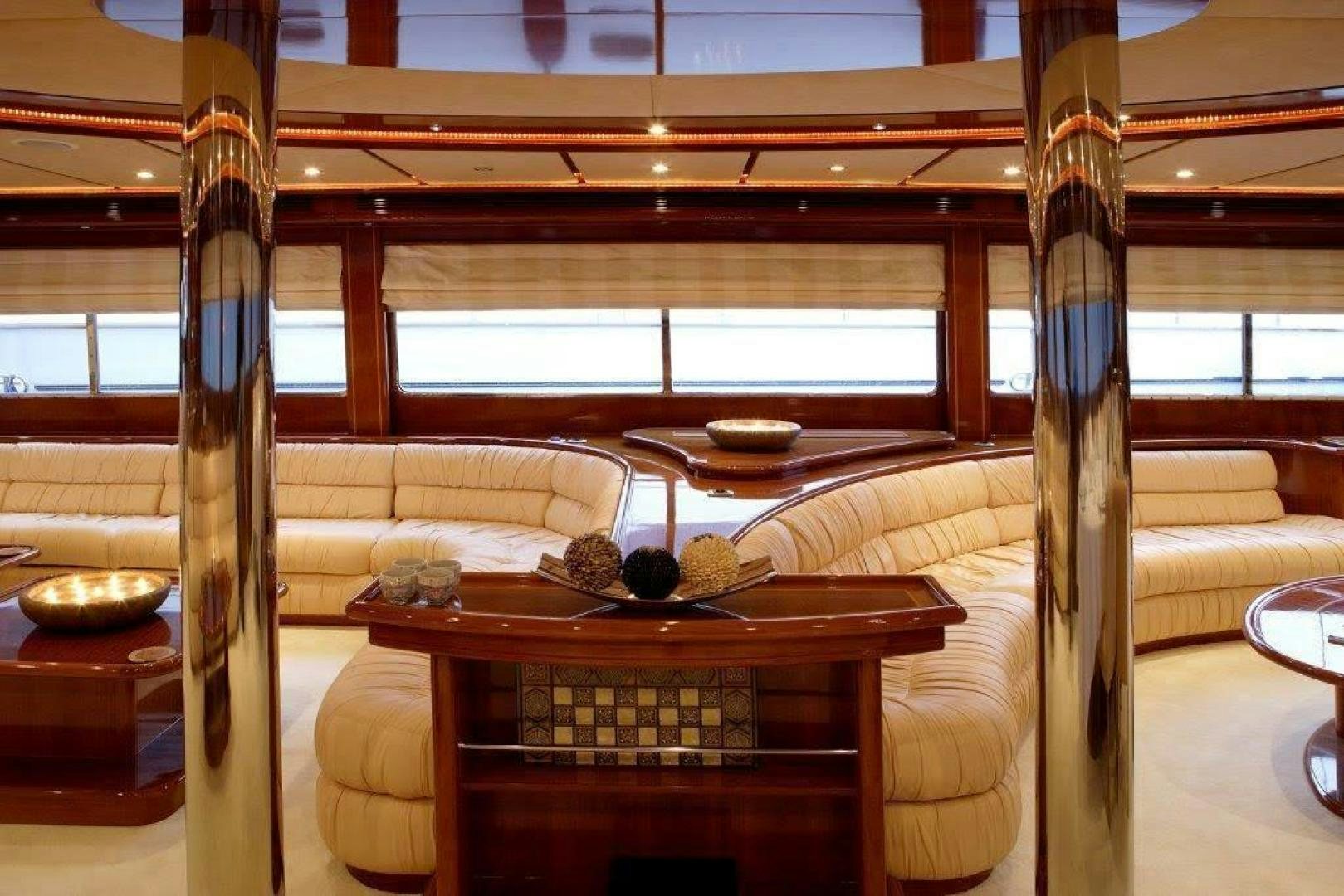 a room with a table and a couch aboard CORVUS Yacht for Sale