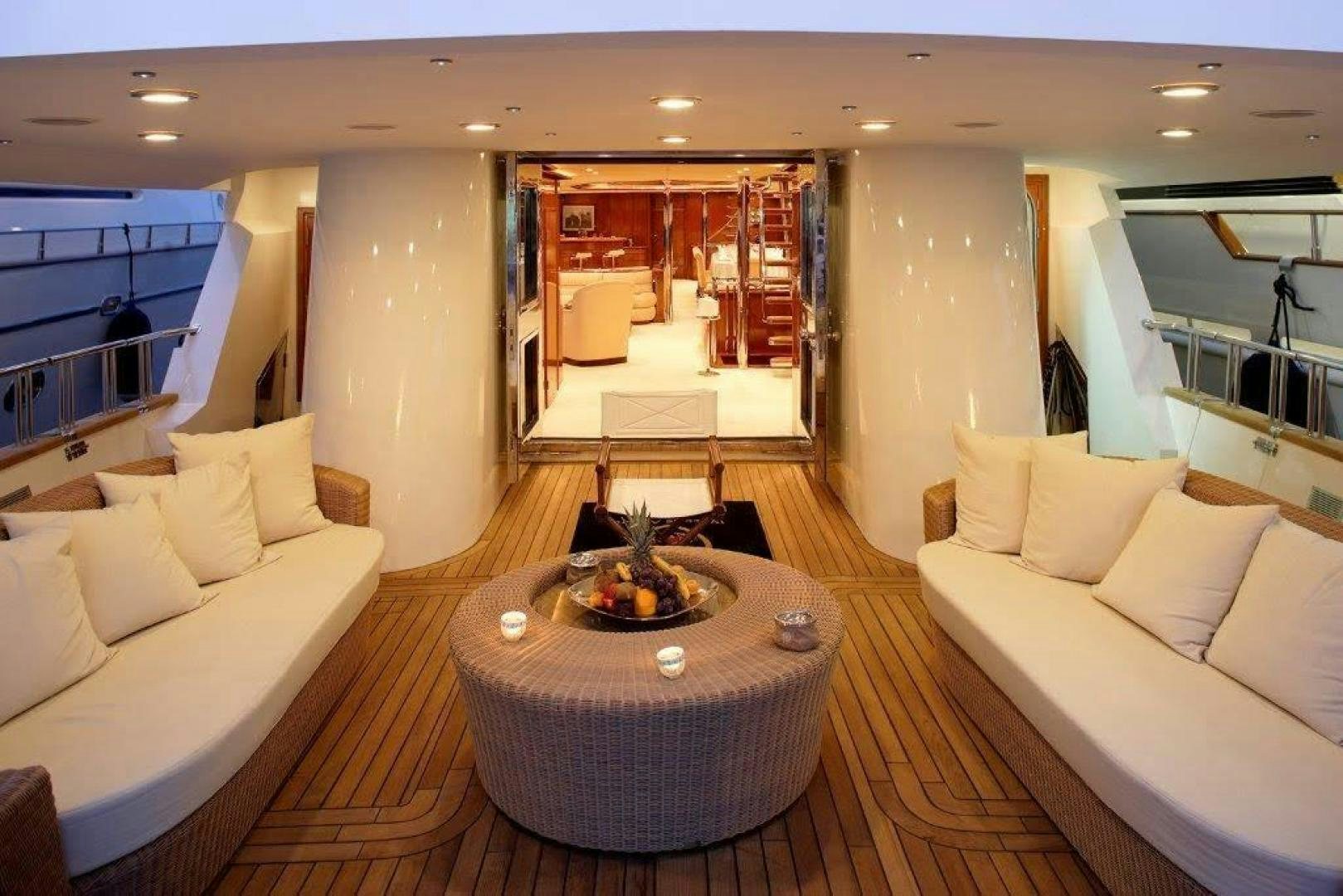a living room with a fireplace aboard CORVUS Yacht for Sale
