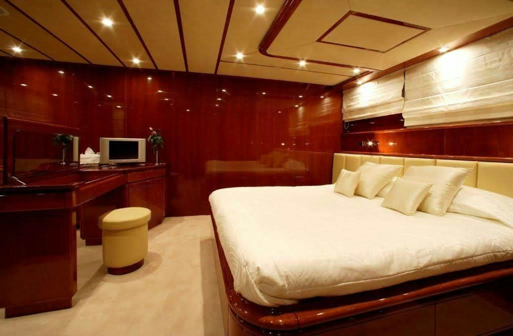 a room with a bed and desk aboard CORVUS Yacht for Sale