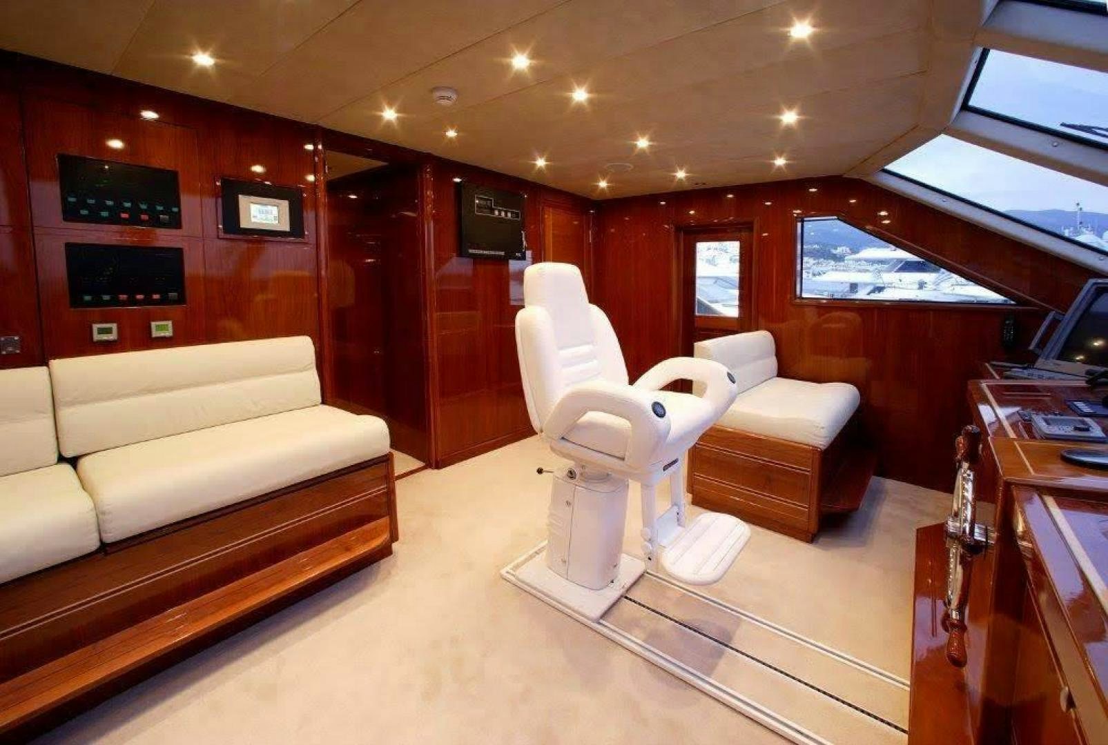 a room with a couch and a table and a television aboard CORVUS Yacht for Sale