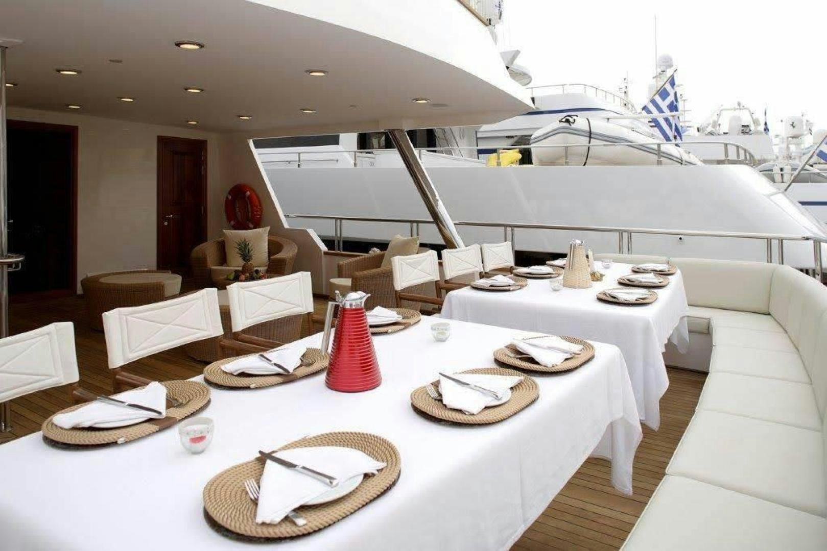 a room with a table and chairs aboard CORVUS Yacht for Sale