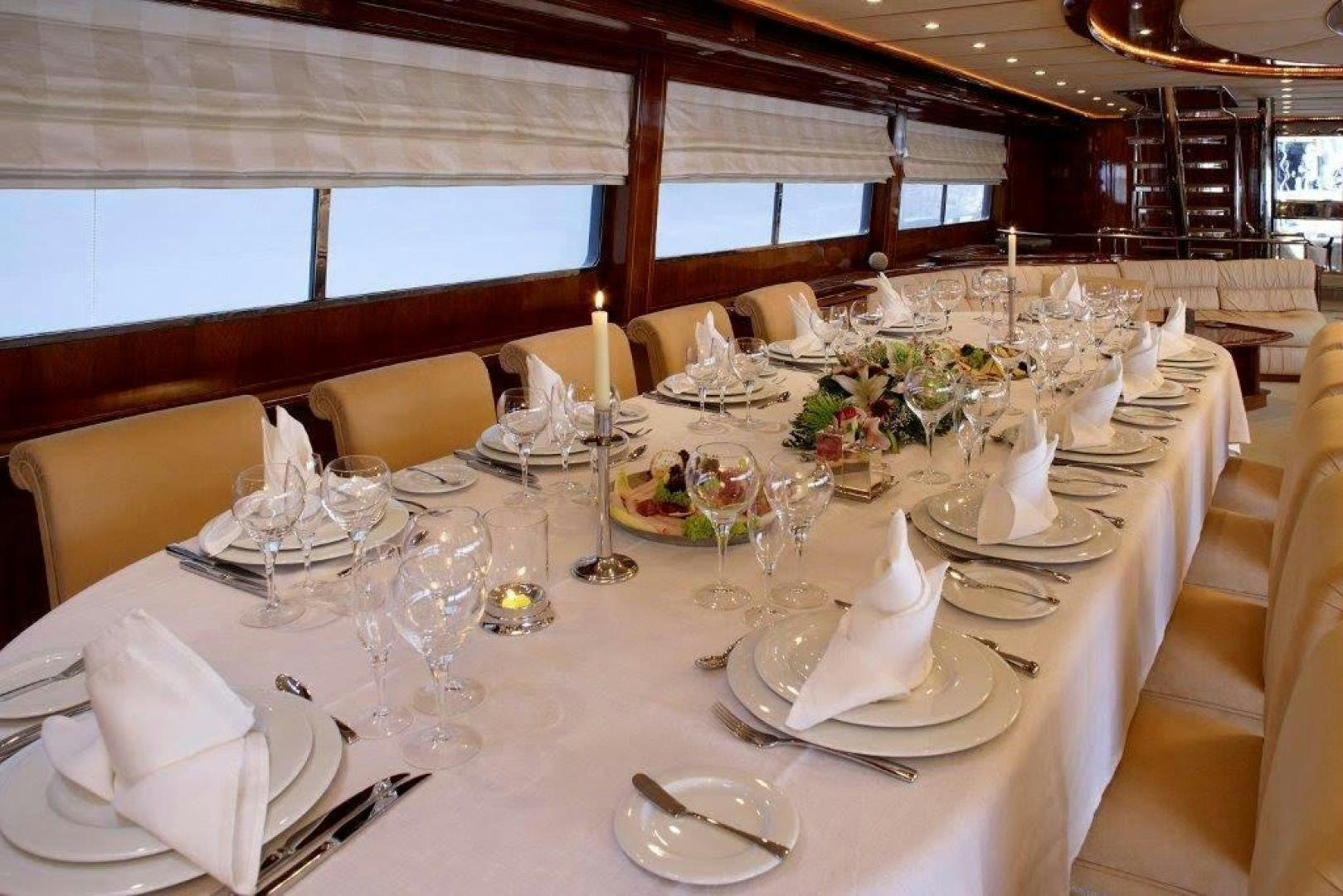 a table set for a formal dinner aboard CORVUS Yacht for Sale
