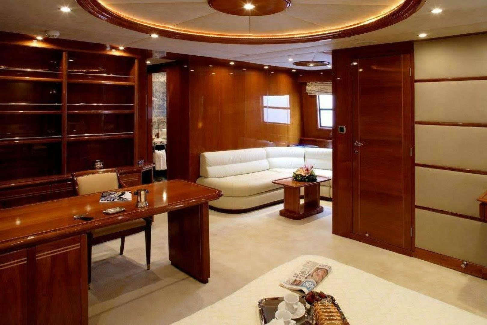a room with a couch and a table aboard CORVUS Yacht for Sale