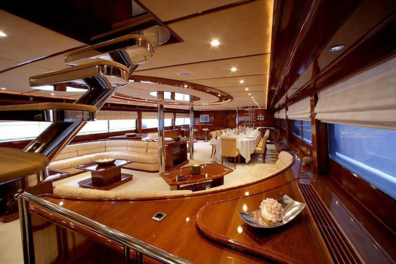 a room with a table and chairs aboard CORVUS Yacht for Sale