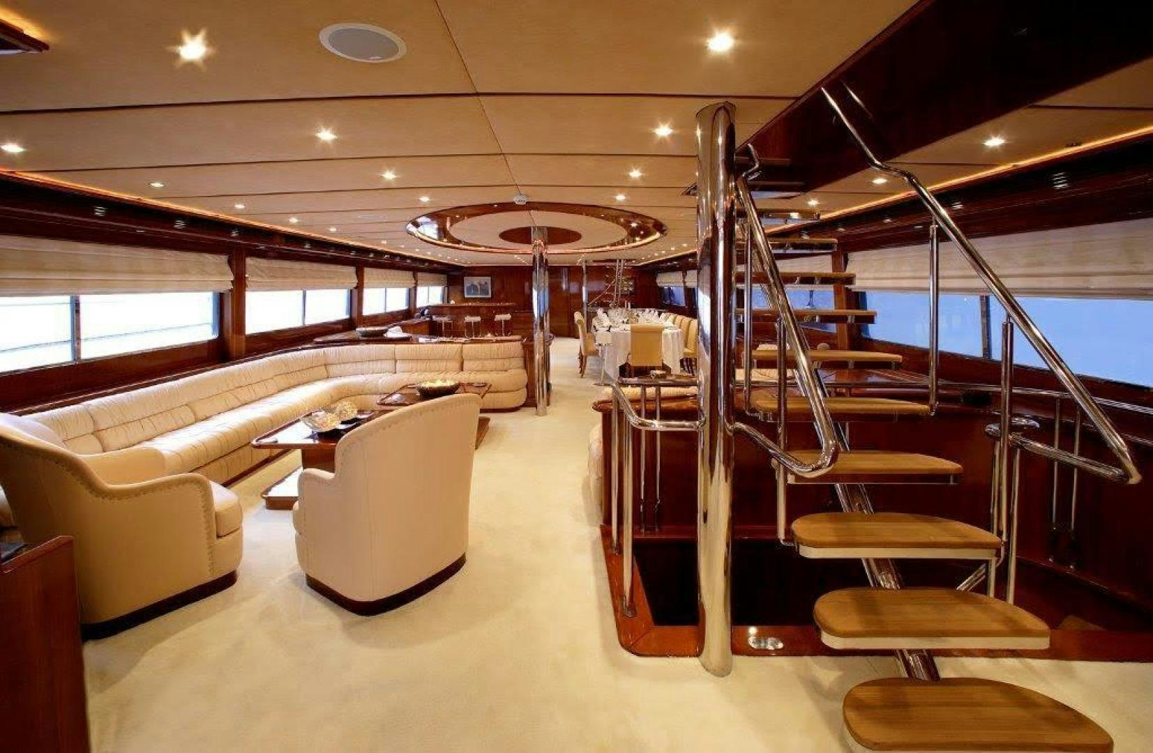 a room with a couch and chairs aboard CORVUS Yacht for Sale