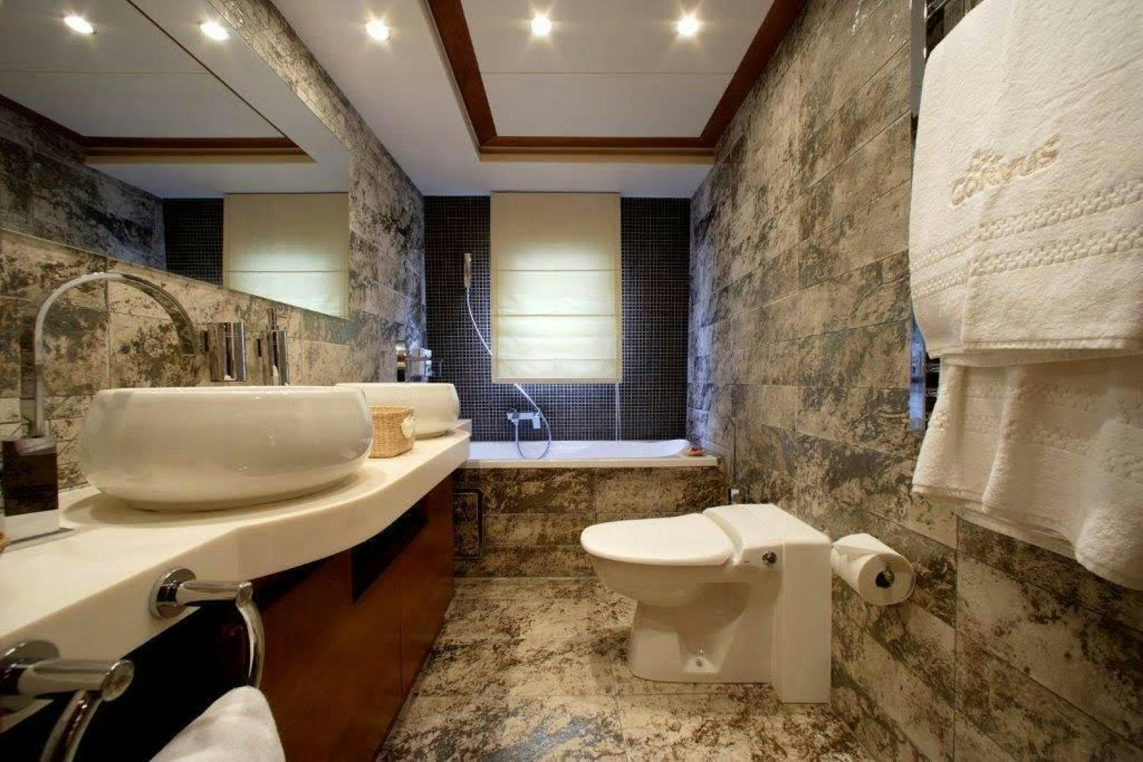 a bathroom with a sink toilet and a bathtub aboard CORVUS Yacht for Sale