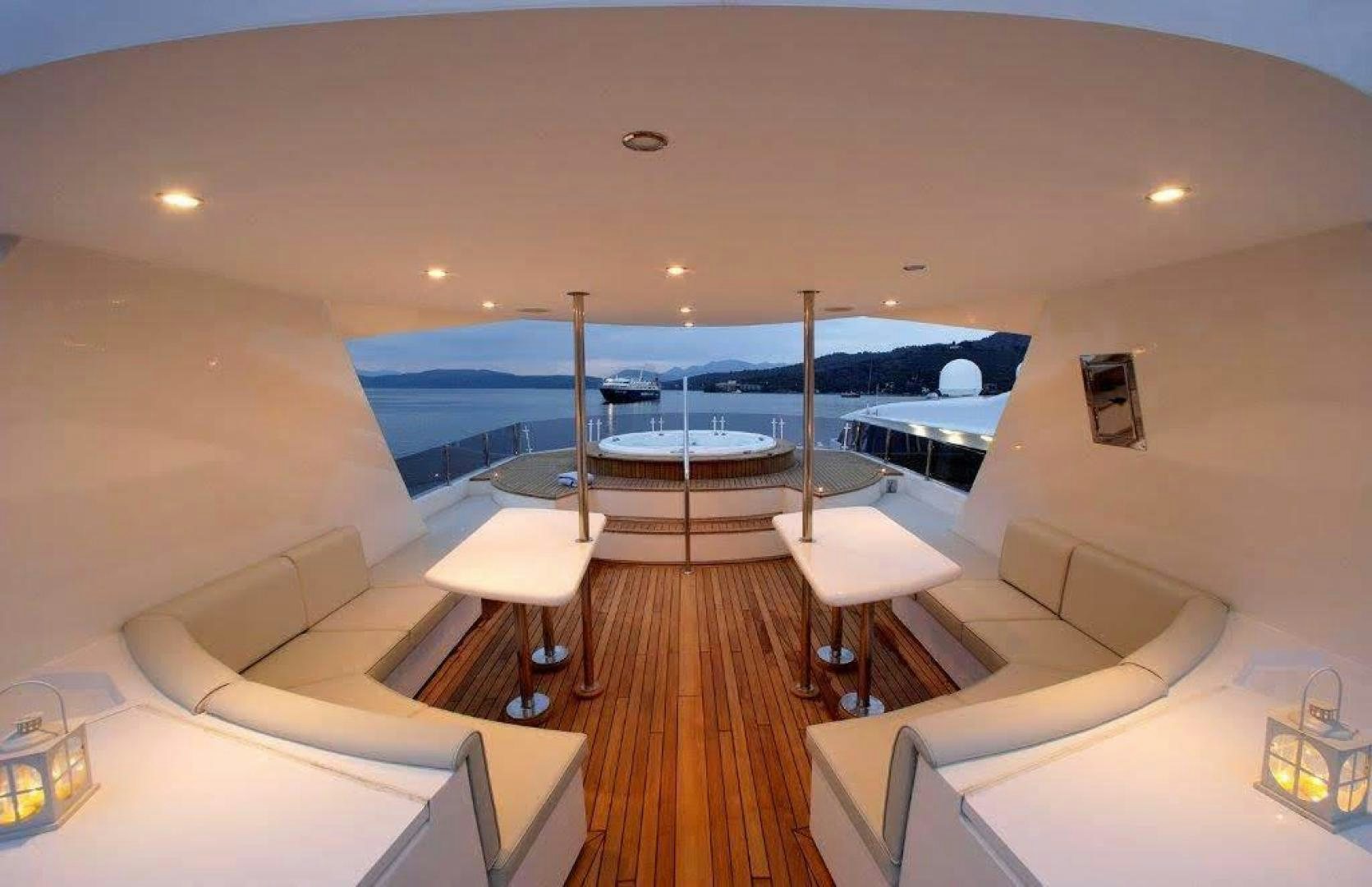 a room with a pool and a deck with a deck and a large pool and a deck with aboard CORVUS Yacht for Sale