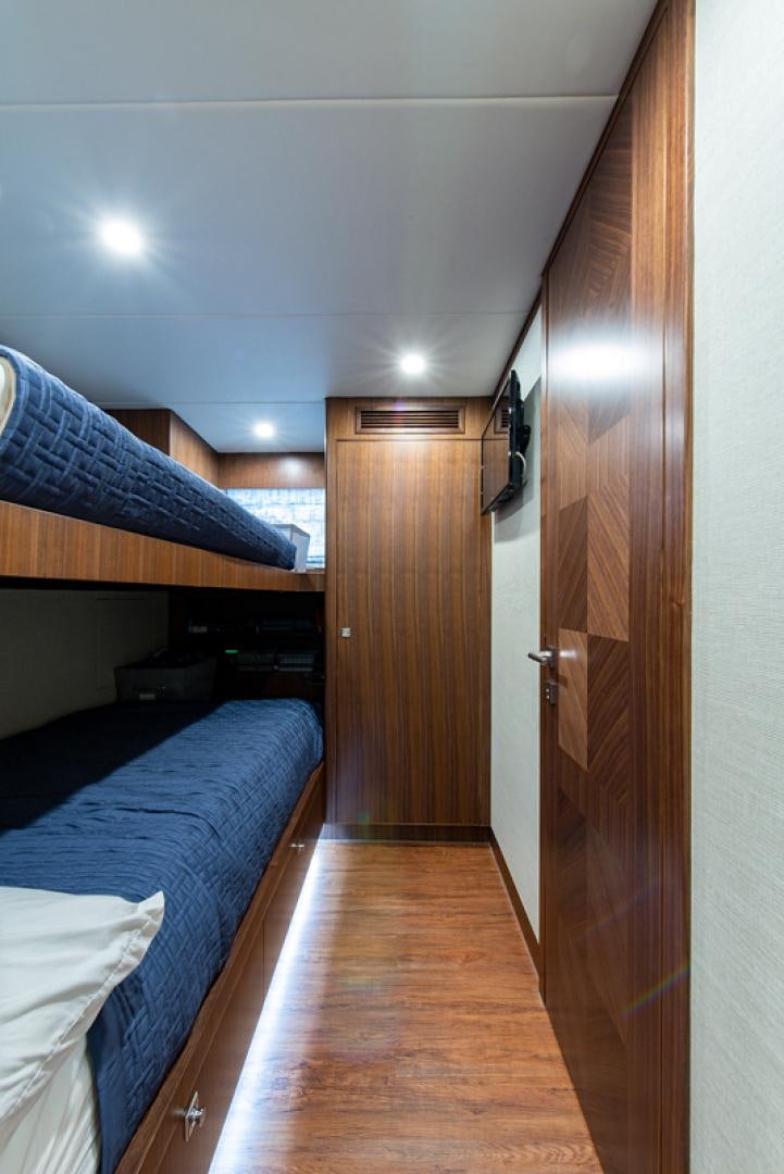 a room with a bed and a wood door aboard GALATI G120 SIGNATURE SERIES Yacht for Sale