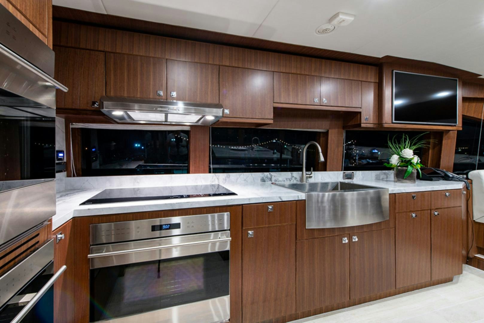 a kitchen with wooden cabinets aboard GALATI G120 SIGNATURE SERIES Yacht for Sale