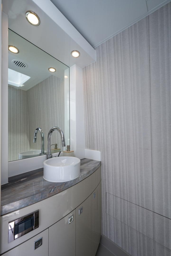 a bathroom with a sink and a mirror aboard GALATI G120 SIGNATURE SERIES Yacht for Sale