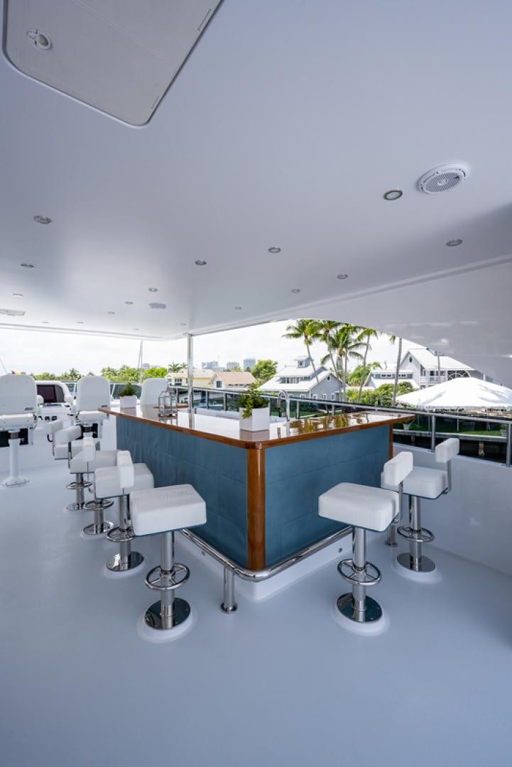 a room with tables and chairs aboard GALATI G120 SIGNATURE SERIES Yacht for Sale