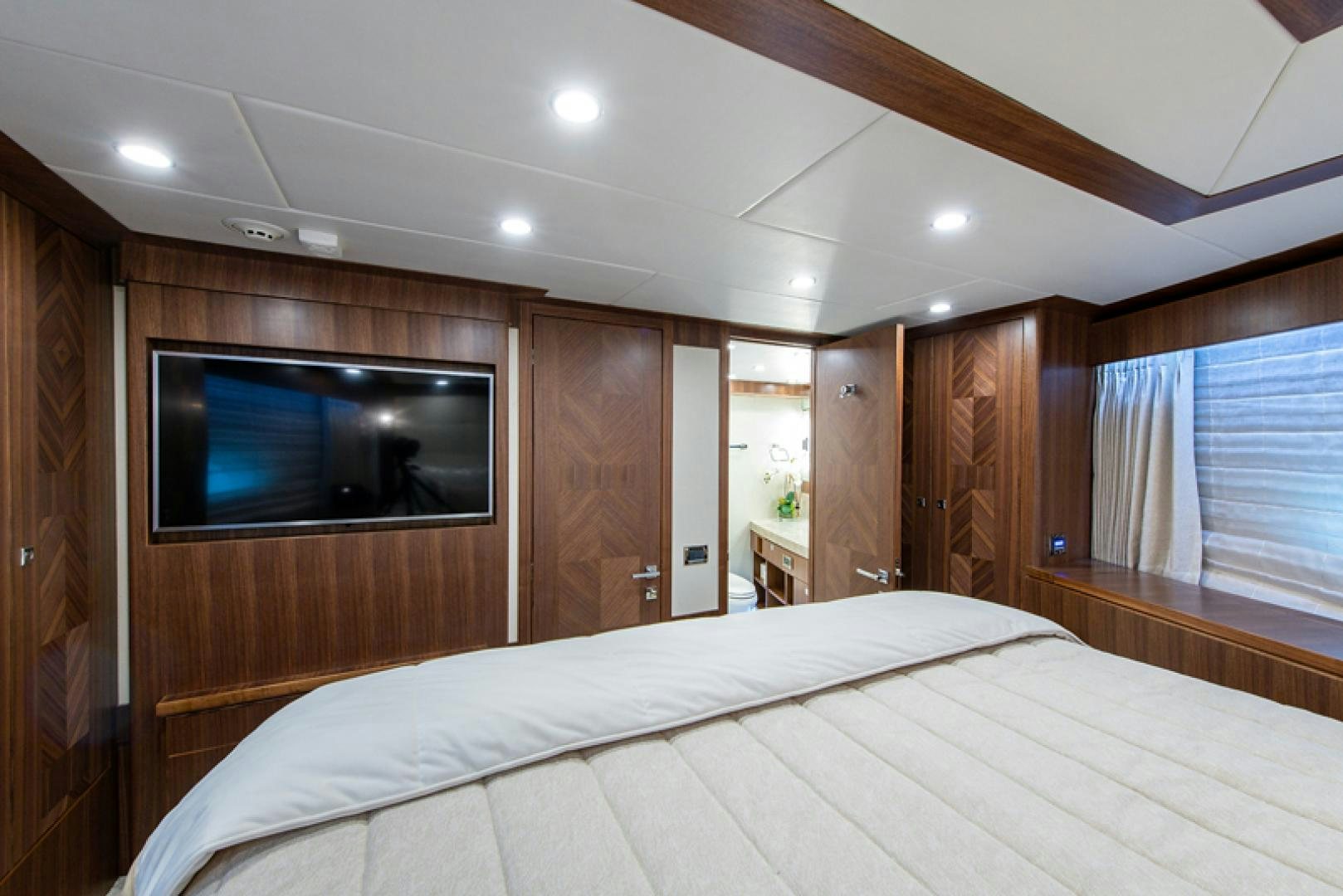 a bedroom with a bed and a television aboard GALATI G120 SIGNATURE SERIES Yacht for Sale
