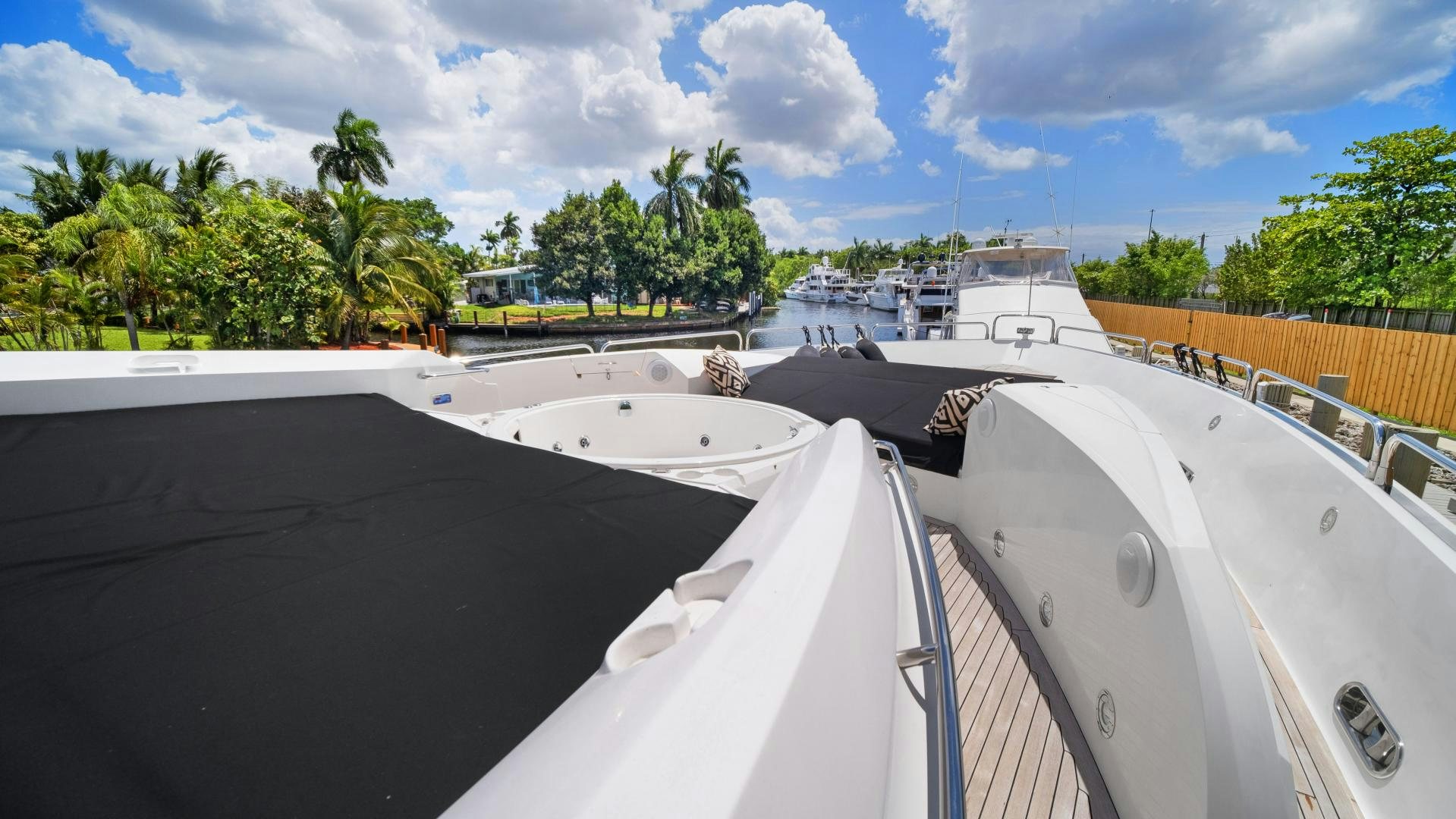a rooftop with a view of a tropical beach and trees aboard DIABLO BLANCO Yacht for Sale