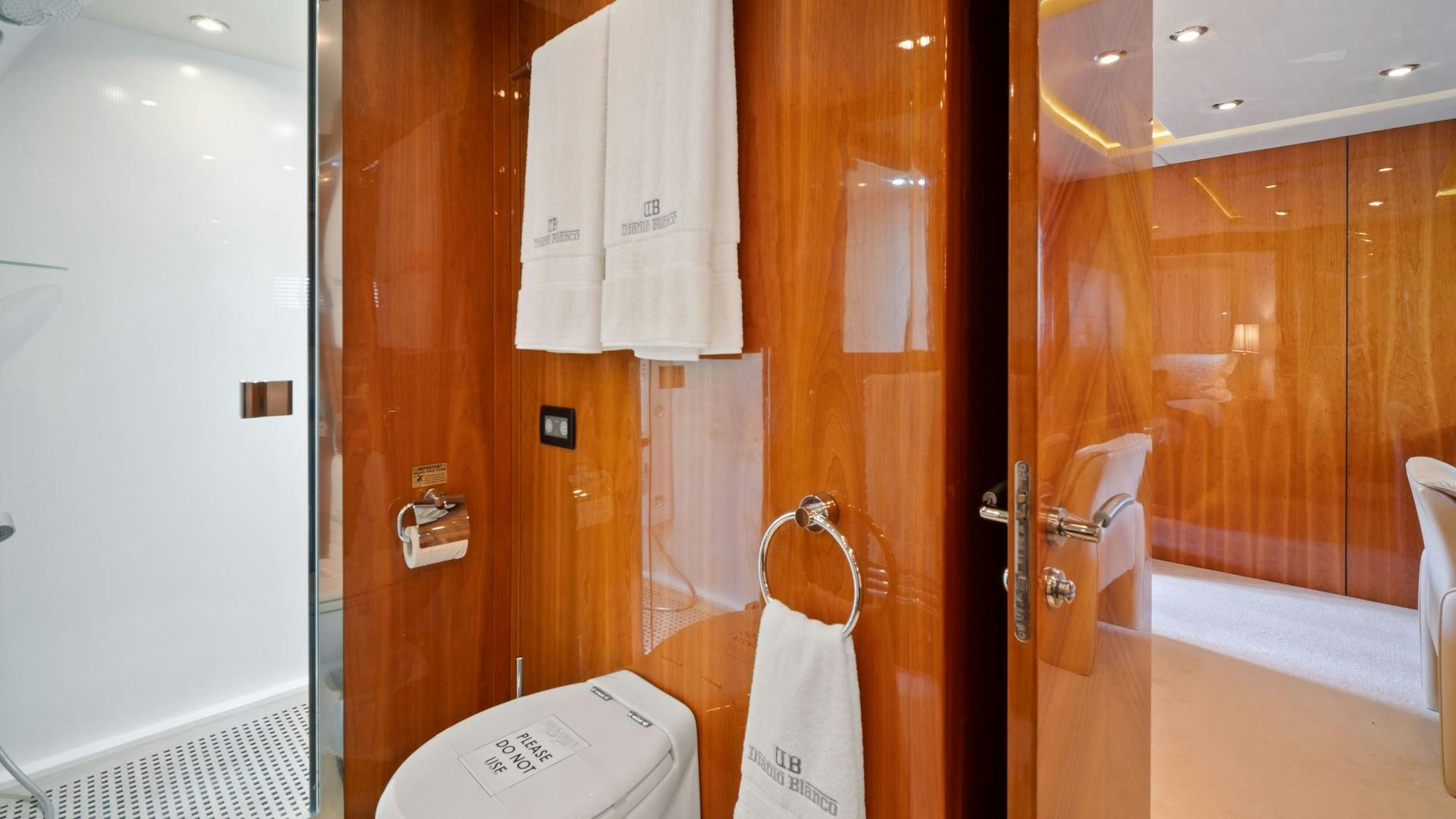a bathroom with a toilet and a shower unit aboard DIABLO BLANCO Yacht for Sale