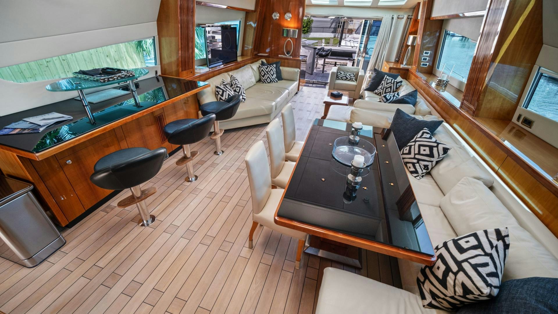a living room with a table and chairs aboard DIABLO BLANCO Yacht for Sale