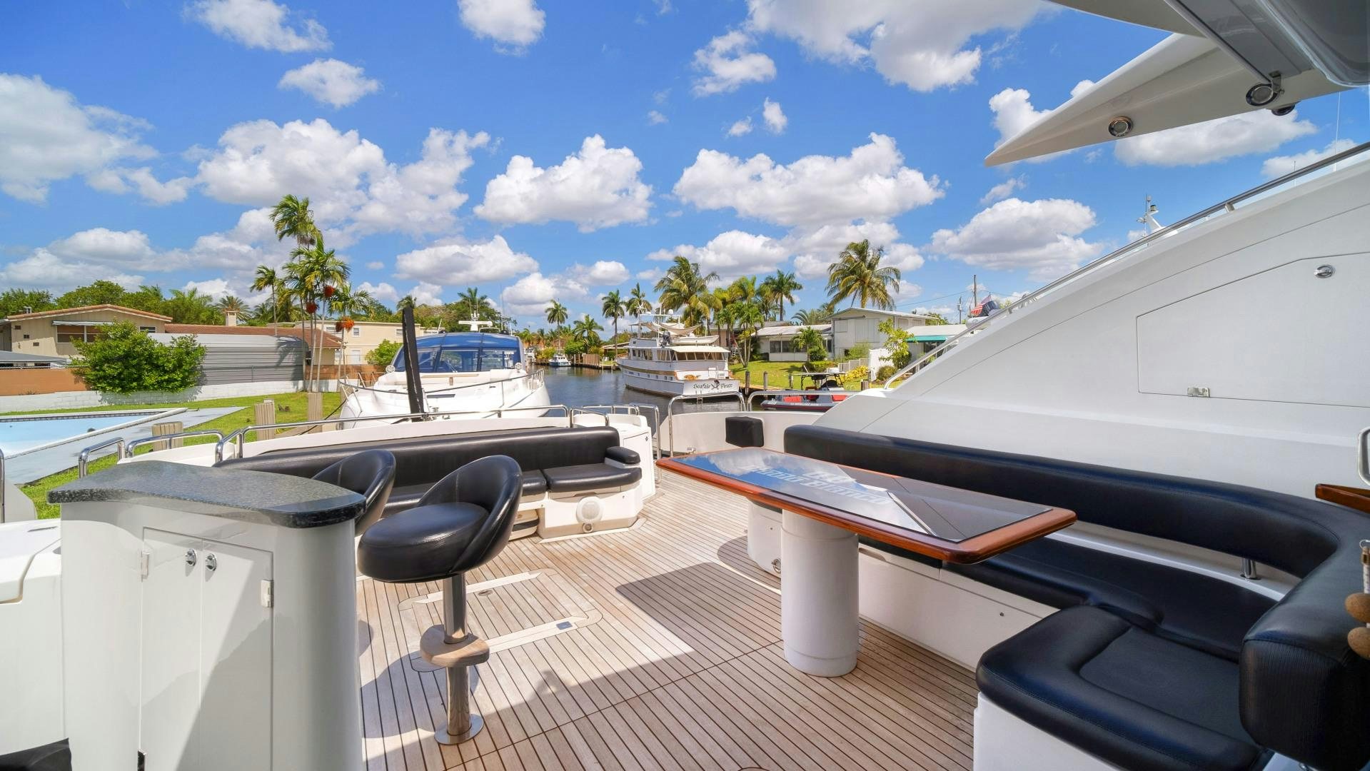 a deck with a chair and boats aboard DIABLO BLANCO Yacht for Sale