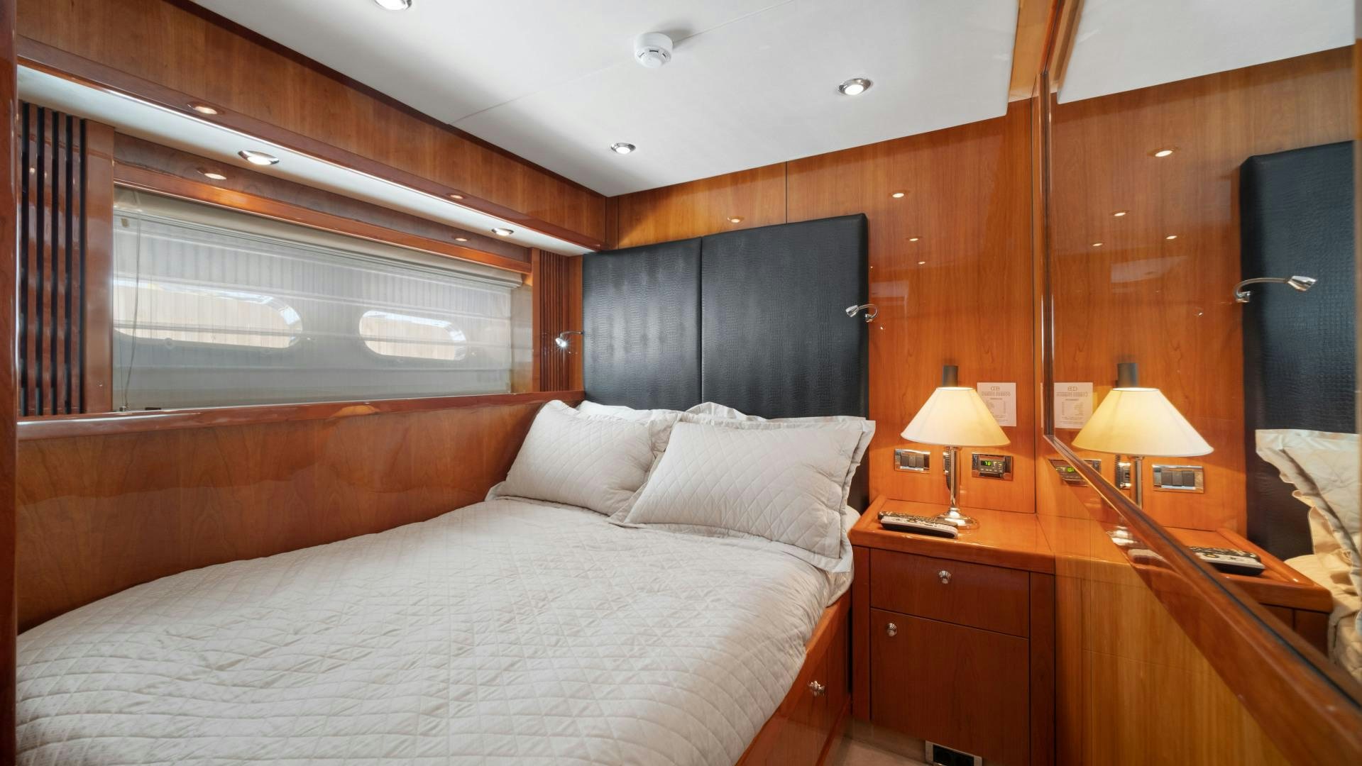a bedroom with a bed and a desk aboard DIABLO BLANCO Yacht for Sale