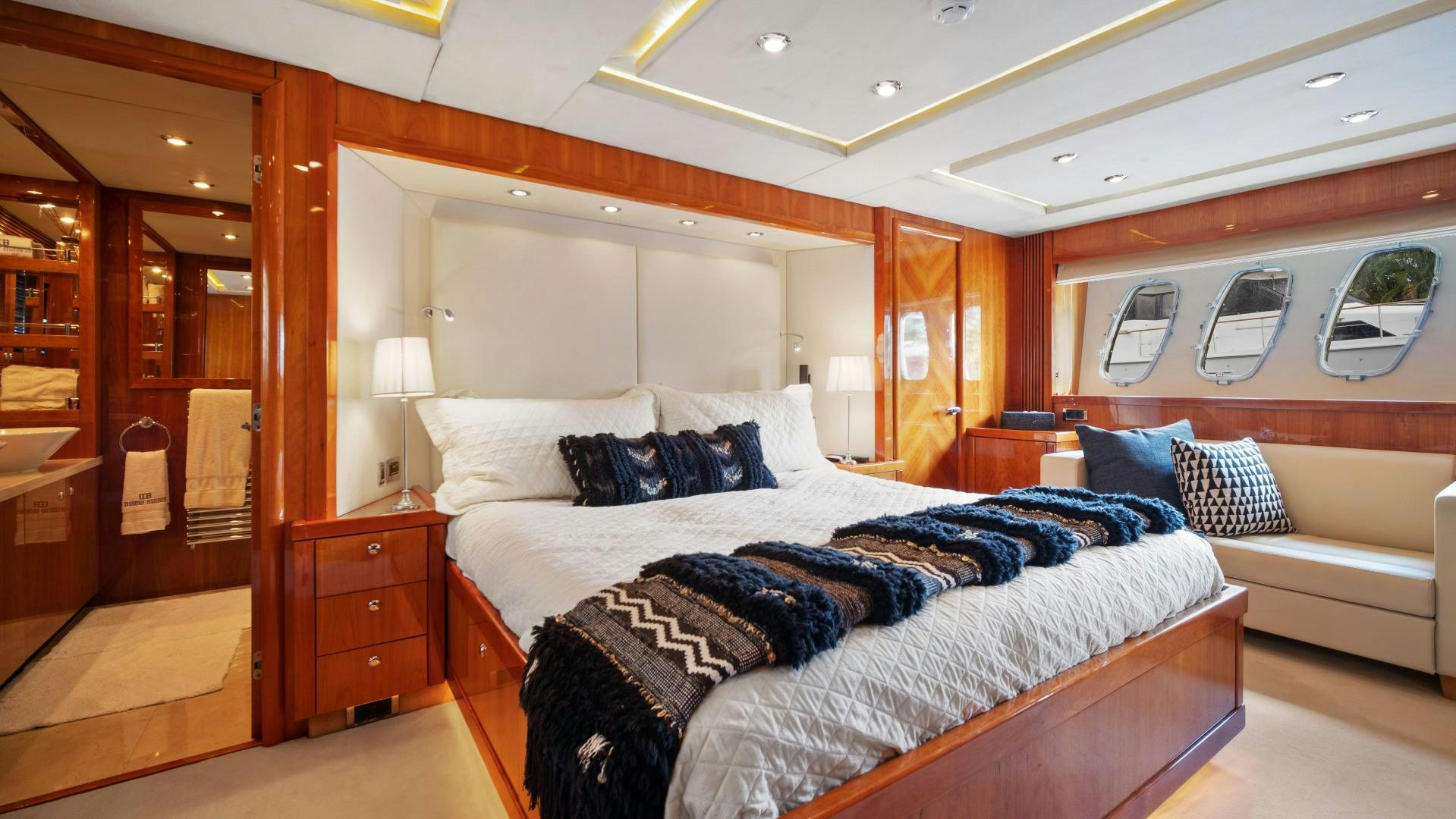 a room with a bed and a mirror aboard DIABLO BLANCO Yacht for Sale