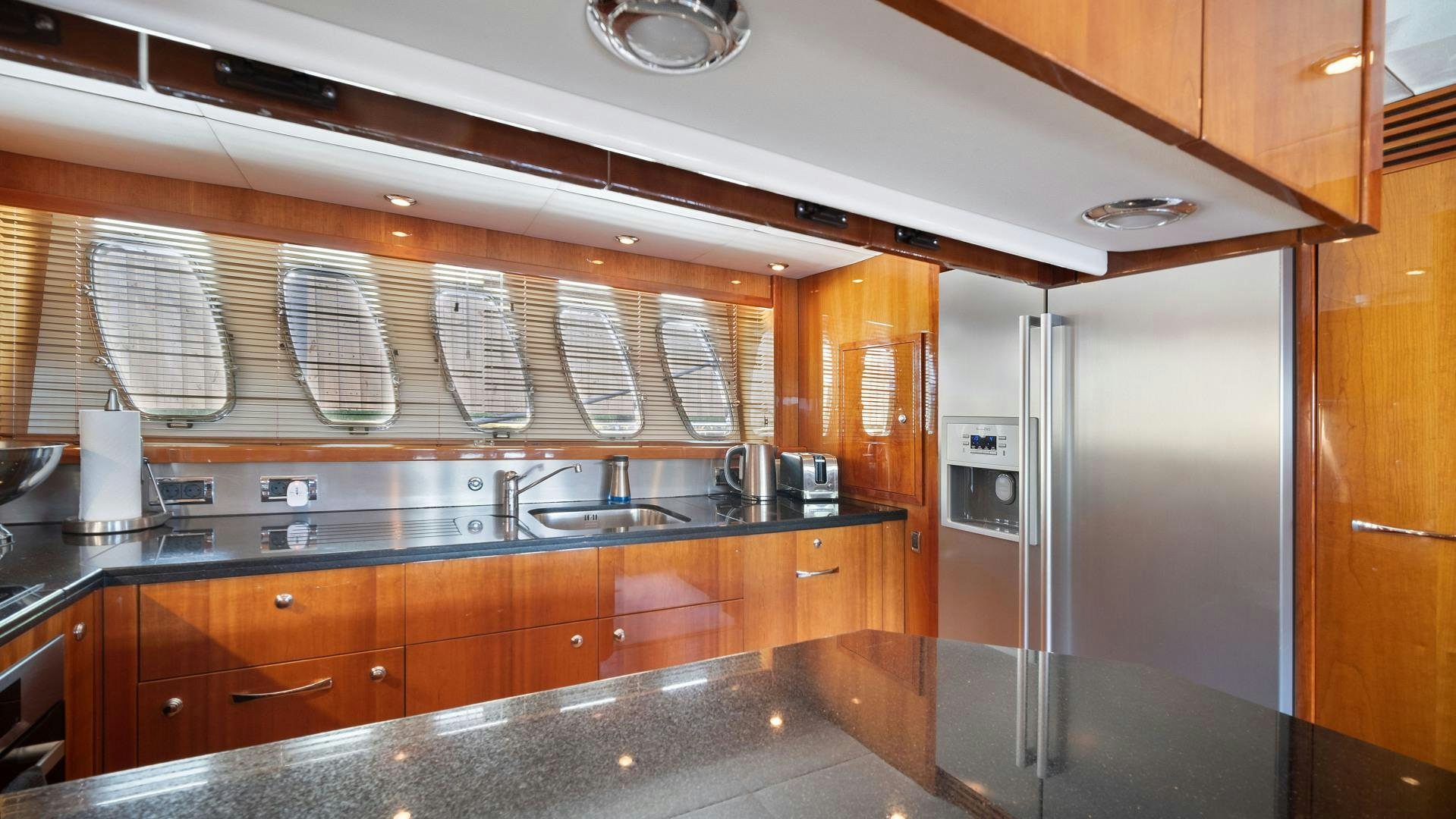 a kitchen with a stainless steel refrigerator aboard DIABLO BLANCO Yacht for Sale