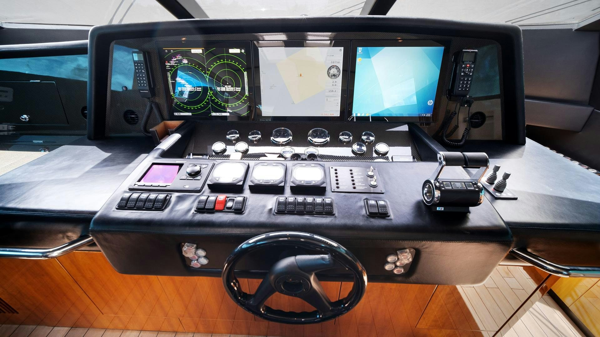 a black computer with a keyboard and monitor and other electronic devices aboard DIABLO BLANCO Yacht for Sale