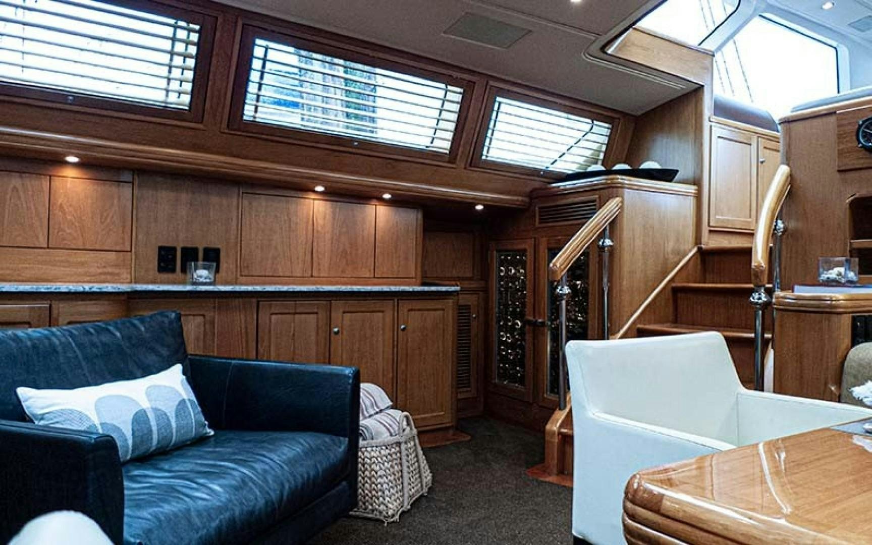 a living room with a couch and a table aboard AVALON Yacht for Sale