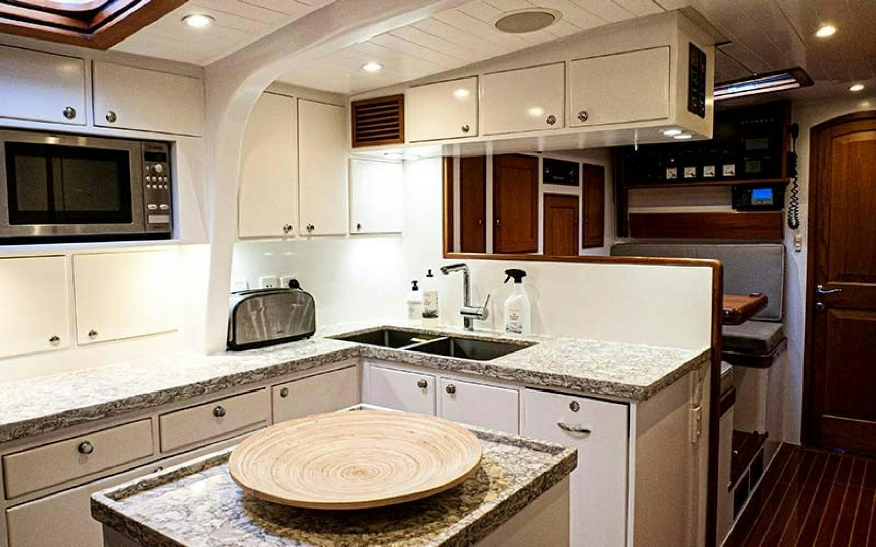 a kitchen with a large island aboard AVALON Yacht for Sale