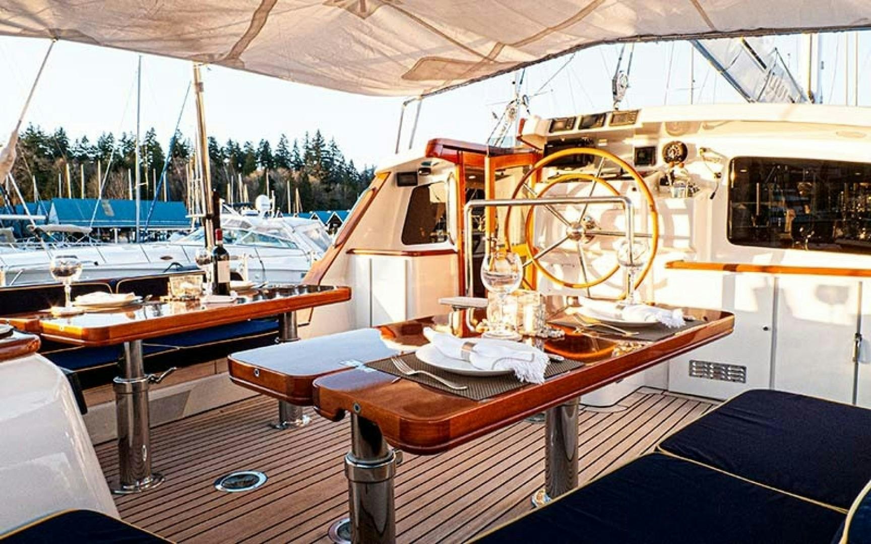 a boat with a table and a fan on the deck aboard AVALON Yacht for Sale