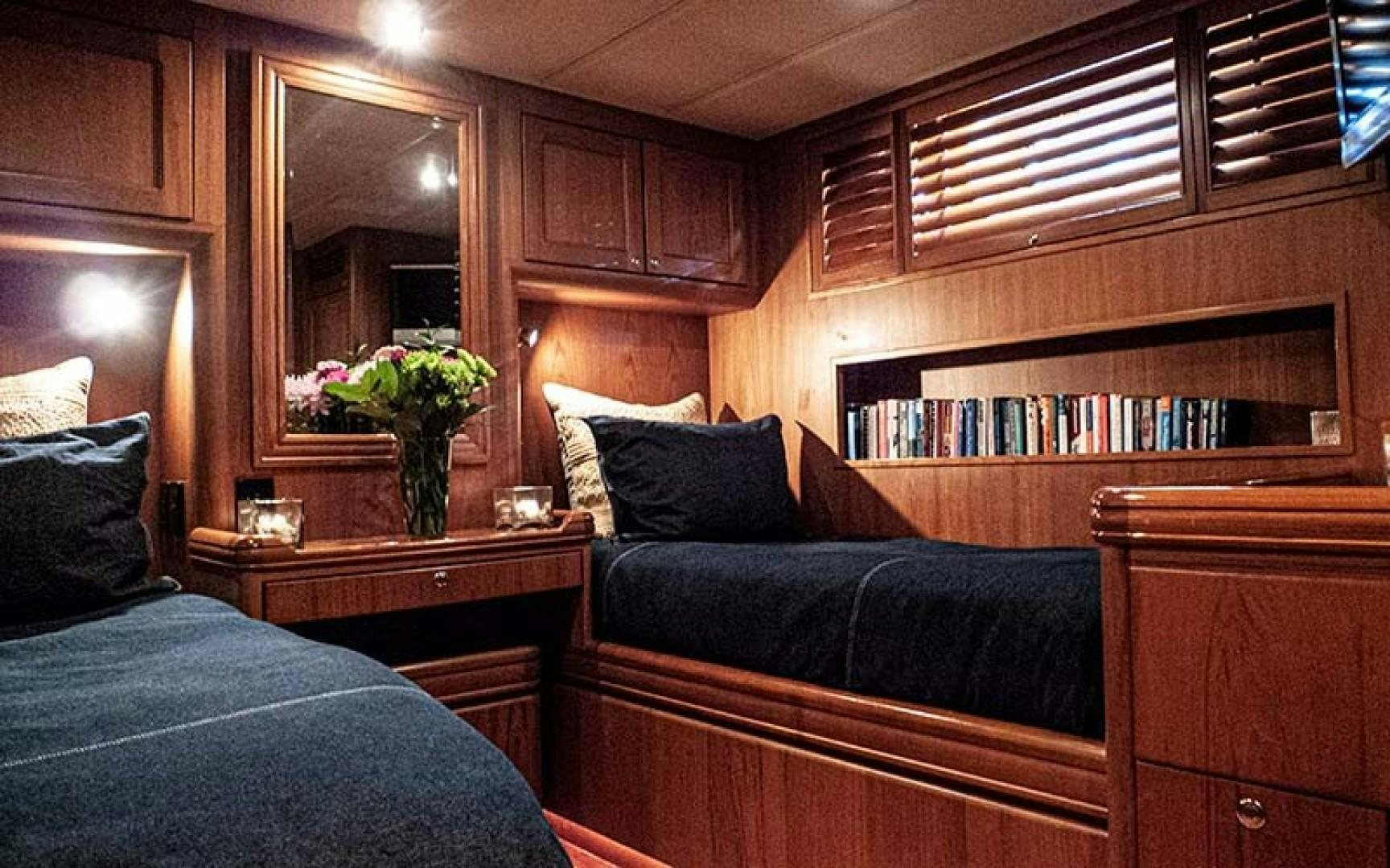 a room with a bed and a mirror aboard AVALON Yacht for Sale