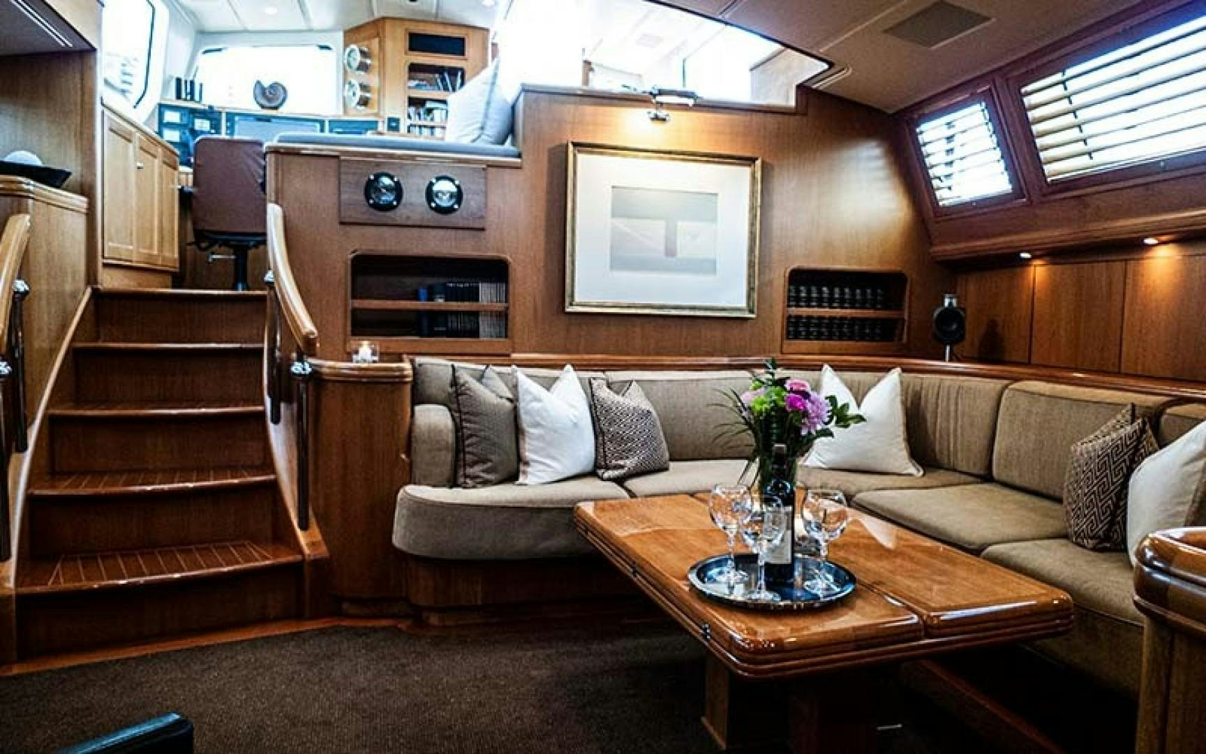a living room with a couch and a coffee table aboard AVALON Yacht for Sale