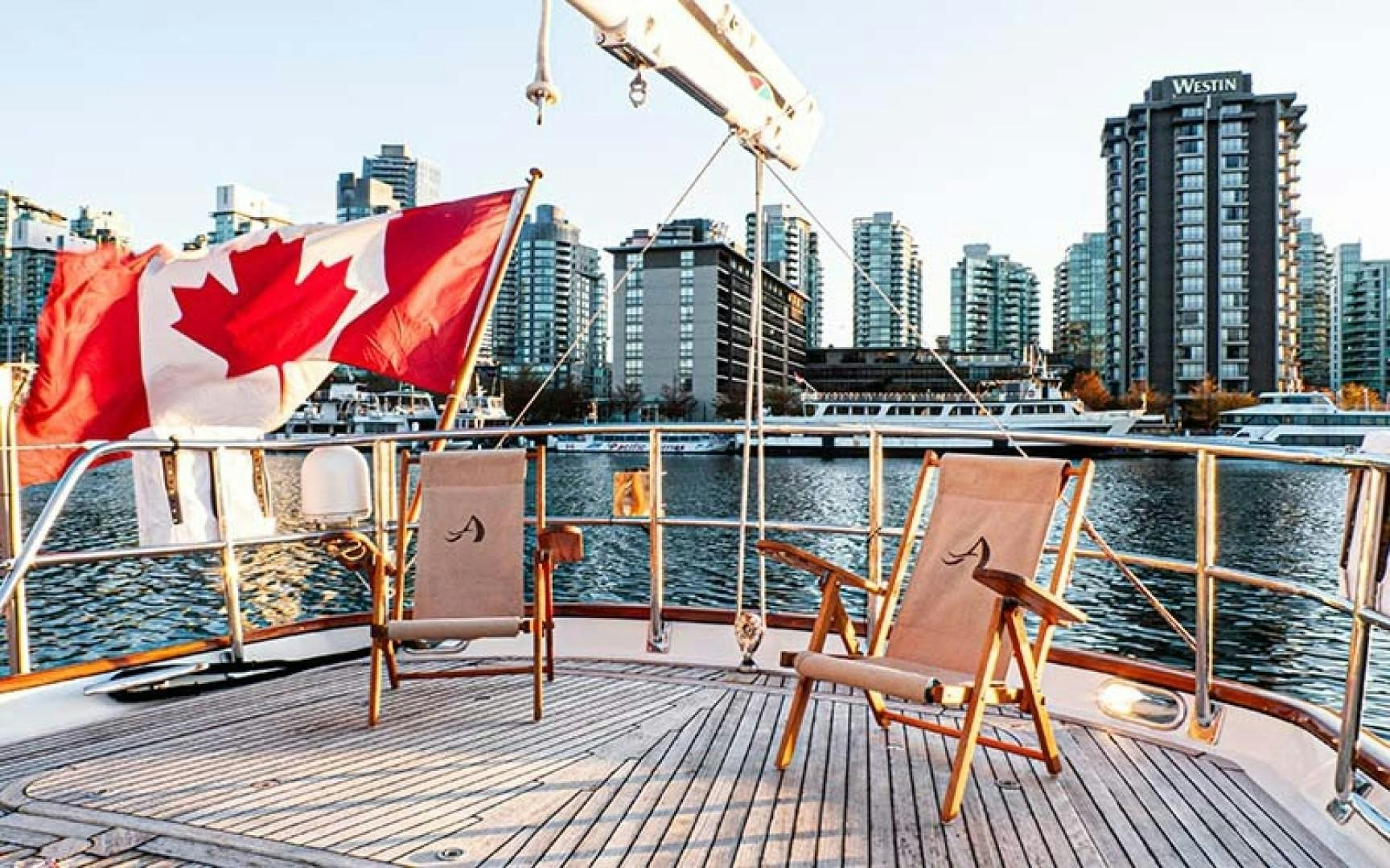 a deck with a flag and a city in the background aboard AVALON Yacht for Sale