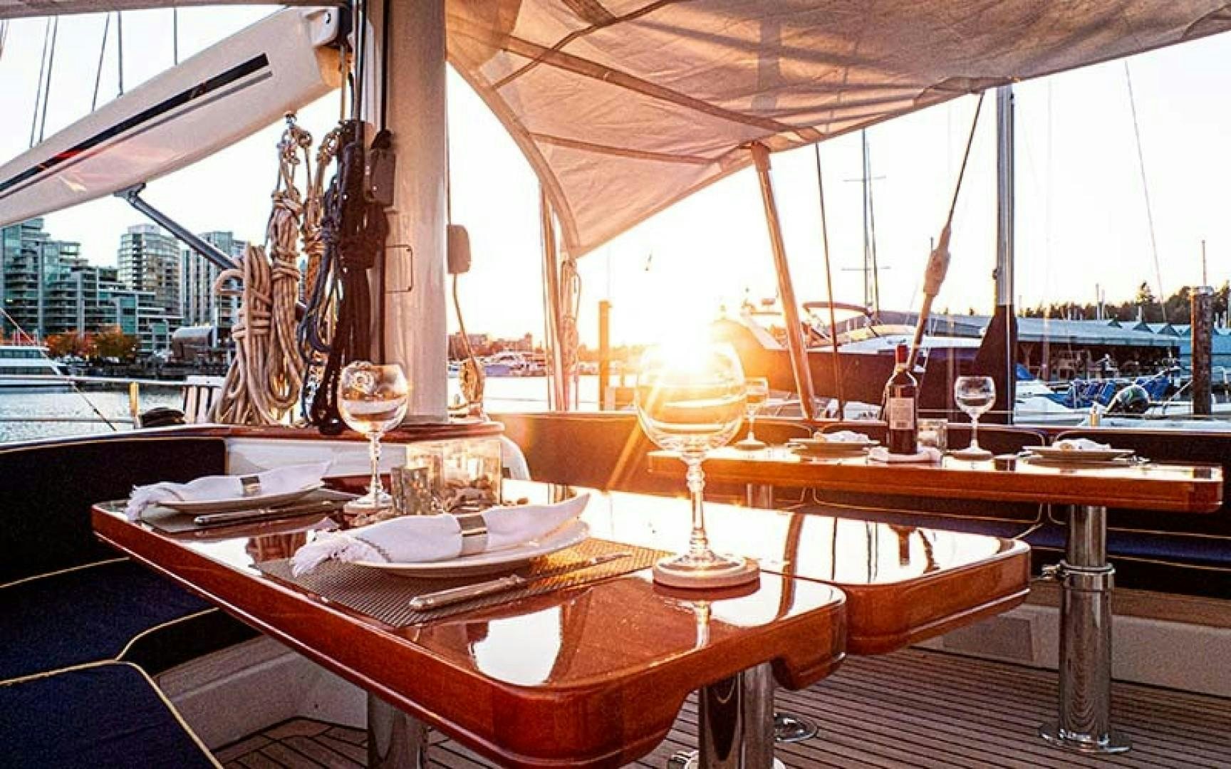 a table with wine glasses on it aboard AVALON Yacht for Sale