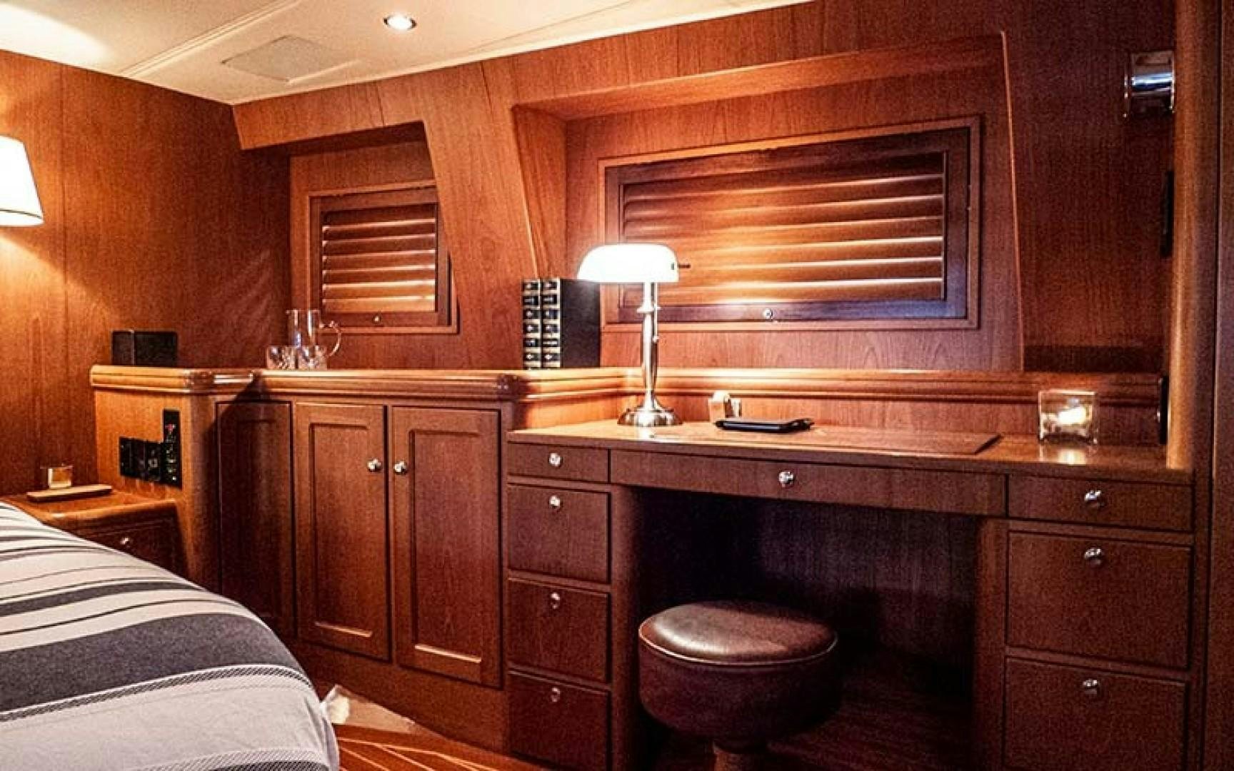 a room with a bed and a desk aboard AVALON Yacht for Sale